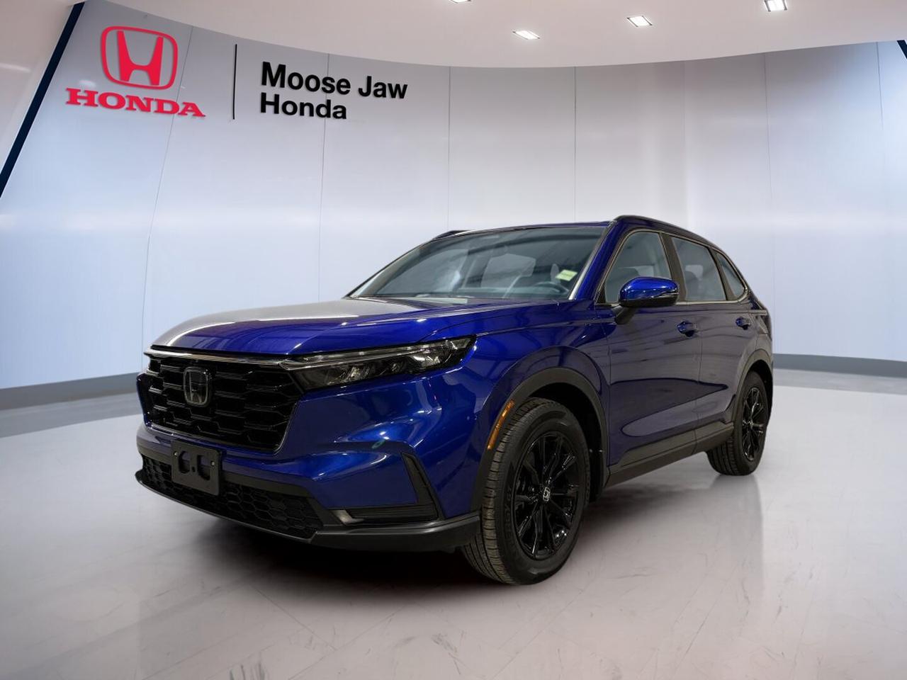 The 2023 Honda CR-V Sport-B is a smart choice for daily life in Saskatchewan. This used SUV is finished in blue and offers confident all-wheel drive, a smooth continuously variable transmission, and a turbocharged 1.5-litre four-cylinder engine. CARFAX Canada reports no accident and one previous owner, giving you added peace of mind.

At Moose Jaw Honda in Moose Jaw, this 2023 Honda CR-V Sport-B stands out for its modern design, strong utility, and easy road manners. With 54,306 km on the odometer, it is ready for commuting, family travel, and weekend errands. It delivers the comfort and flexibility drivers expect from a well-rounded Honda SUV.

FEATURES OF THE CR-V Sport-B

»» Turbocharged 1.5-litre four-cylinder engine
»» Continuously variable transmission for smooth driving
»» All-wheel drive for added traction
»» Blue exterior with modern SUV styling

ADVANCED SAFETY FEATURES

»» Advanced airbag system for occupant protection
»» Vehicle Stability Assist helps maintain control
»» Anti-lock braking system supports safer stops
»» Tire Pressure Monitoring System adds awareness

PERFORMANCE AND EFFICIENCY

»» Turbo engine delivers responsive everyday power
»» CVT supports smooth and steady acceleration
»» All-wheel drive improves year-round confidence
»» Efficient design helps reduce fuel use

COMFORT AND CONVENIENCE

»» Spacious cabin for daily family comfort
»» Four-door access makes entry very easy
»» Flexible seating supports passenger versatility
»» Practical layout keeps controls within reach

TECHNONOLGY AND CONNECTIVITY

»» Driver information display keeps data visible
»» Easy controls support simple daily operation
»» Modern cabin design feels clean, useful
»» Connectivity features support everyday convenience

CARGO SPACE

»» Rear cargo area suits daily errands
»» Wide opening helps load larger items
»» Flexible interior supports changing cargo needs
»» SUV design balances passengers and gear

AWARDS & RECOGNITIONS

»» Top Safety Pick, Insurance Institute for Highway Safety, 2023

WHAT OTHER OWNERS LIKE

»» Smooth ride quality for daily driving
»» Useful cargo room for family needs
»» Confident all-wheel drive in winter
»» Good fuel economy for an SUV

This 2023 Honda CR-V Sport-B is built for drivers who want value, versatility, and trusted Honda engineering. Its turbocharged powertrain gives it a lively feel, while the all-wheel drive system helps when roads turn wet, snowy, or uneven. The cabin is designed for real life, with room for people, bags, groceries, and sports gear.

This SUV also brings the strong reputation of the CR-V nameplate, known across Canada for comfort, practicality, and long-term dependability. Whether you are heading across Moose Jaw, taking on highway travel, or preparing for changing prairie weather, this 2023 Honda CR-V Sport-B is ready to fit your routine with confidence and ease.

This 2023 Honda CR-V Sport-Bs VIN is: 2HKRS4H59PH127030.<p>The 2023 Honda CR-V Sport-B is a smart choice for daily life in Saskatchewan. This used SUV is finished in blue and offers confident all-wheel drive</p>
<p> and a turbocharged 1.5-litre four-cylinder engine. CARFAX Canada reports no accident and one previous owner</p>
<p> and weekend errands. It delivers the comfort and flexibility drivers expect from a well-rounded Honda SUV.

FEATURES OF THE CR-V Sport-B

»» Turbocharged 1.5-litre four-cylinder engine
»» Continuously variable transmission for smooth driving
»» All-wheel drive for added traction
»» Blue exterior with modern SUV styling

ADVANCED SAFETY FEATURES

»» Advanced airbag system for occupant protection
»» Vehicle Stability Assist helps maintain control
»» Anti-lock braking system supports safer stops
»» Tire Pressure Monitoring System adds awareness

PERFORMANCE AND EFFICIENCY

»» Turbo engine delivers responsive everyday power
»» CVT supports smooth and steady acceleration
»» All-wheel drive improves year-round confidence
»» Efficient design helps reduce fuel use

COMFORT AND CONVENIENCE

»» Spacious cabin for daily family comfort
»» Four-door access makes entry very easy
»» Flexible seating supports passenger versatility
»» Practical layout keeps controls within reach

TECHNONOLGY AND CONNECTIVITY

»» Driver information display keeps data visible
»» Easy controls support simple daily operation
»» Modern cabin design feels clean</p>
<p> useful
»» Connectivity features support everyday convenience

CARGO SPACE

»» Rear cargo area suits daily errands
»» Wide opening helps load larger items
»» Flexible interior supports changing cargo needs
»» SUV design balances passengers and gear

AWARDS & RECOGNITIONS

»» Top Safety Pick</p>
<p> 2023

WHAT OTHER OWNERS LIKE

»» Smooth ride quality for daily driving
»» Useful cargo room for family needs
»» Confident all-wheel drive in winter
»» Good fuel economy for an SUV

This 2023 Honda CR-V Sport-B is built for drivers who want value</p>
<p> this 2023 Honda CR-V Sport-B is ready to fit your routine with confidence and ease.

This 2023 Honda CR-V Sport-Bs VIN is: 2HKRS4H59PH127030.</p>