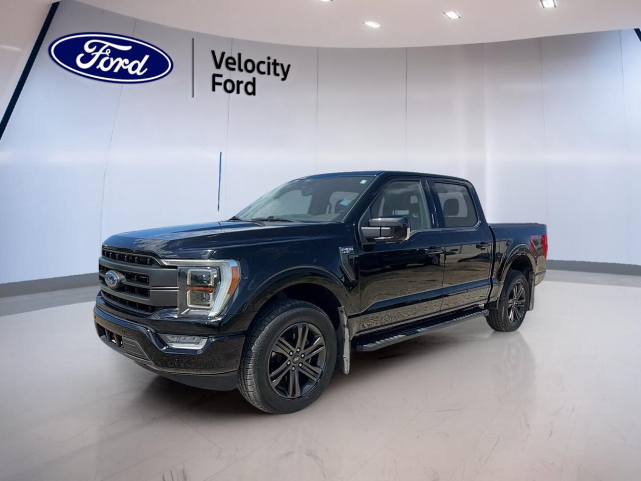 Built for hard work and daily comfort, this used 2022 Ford F-150 LARIAT 4WD SuperCrew 5.5 Box is ready for life in Moose Jaw. It blends V8 power, four-door practicality, and a refined cabin with the confidence truck buyers expect. Finished in Black with a Black interior, it has 54,503 km and an automatic transmission.

Under the hood, this 2022 Ford F-150 LARIAT 4WD SuperCrew 5.5 Box features a 5.0-litre unleaded V8 engine paired with four-wheel drive for strong pull and sure footing. Its 4,717 kg towing capacity makes it well suited for trailers, work gear, and weekend toys, while the 5.5-foot box adds useful everyday hauling flexibility.

FEATURES OF THE F-150 LARIAT 4WD SuperCrew 5.5 Box
»» Four full doors for easy access
»» Black exterior with bold road presence
»» Automatic transmission for smooth daily driving
»» 55,000 km showing solid value

TRUCK FEATURES
»» Tows up to 4,717 kg confidently
»» Four-wheel drive for added traction
»» 5.5-foot box for versatile hauling
»» Rear tow hook supports truck utility

ADVANCED SAFETY FEATURES
»» Anti-lock brakes help maintain control
»» Stability control adds secure handling
»» Backup camera aids reversing visibility
»» Blind spot monitor boosts awareness

PERFORMANCE AND EFFICIENCY
»» 5.0-litre V8 delivers strong output
»» Automatic transmission shifts smoothly every day
»» Off-road tires support rougher terrain
»» Cruise control helps on long trips

COMFORT AND CONVENIENCE
»» Heated front seats for cold mornings
»» Dual-zone climate control adds comfort
»» Remote starter warms truck before driving
»» Memory seats simplify shared driving

TECHNOLOGY AND CONNECTIVITY
»» Navigation system helps guide each trip
»» Bluetooth integration supports hands-free calling
»» WiFi hotspot keeps devices connected
»» Steering wheel audio controls add ease

CARGO SPACE
»» SuperCrew cabin offers useful rear room
»» Rear trunk access helps loading gear
»» Spare tire adds roadside peace
»» Power windows improve daily convenience

AWARDS & RECOGNITIONS
»» North American Truck of the Year, North American Car, Truck and Utility Vehicle of the Year, 2021

WHAT OTHER OWNERS LIKE
»» Strong V8 power for towing confidence
»» Spacious cabin with useful rear seating
»» Smooth ride for everyday truck use
»» Easy tech features and clear controls

This Ford pickup also includes practical features that add value every day. You get power steering, power windows, heated mirrors, electric mirrors, retractable mirrors, tinted windows, fog lights, LED headlamps, automatic headlights, tire pressure monitoring, and automatic door locks. These features help make driving simpler in changing Prairie weather.

Inside, the cabin is equipped for comfort and control. Highlights include front air conditioning, automatic climate control, adjustable pedals, an adjustable steering wheel, a leather steering wheel, ambient lighting, driver lumbar support, passenger lumbar support, a power driver seat, a power passenger seat, and an auto-dimming rearview mirror. Push-button start adds easy access when you are on the go.

This truck also supports safer family travel with child safety locks, driver and passenger airbags, side impact airbags, head side airbags, and a passenger airbag sensor. Turn signal mirrors, a rear window defroster, satellite radio, HD Radio, and illuminated vanity mirrors round out a well-equipped package from Velocity Ford.

This 2022 Ford F-150 LARIAT 4WD SuperCrew 5.5 Boxs VIN is: 1FTFW1E56NKD13536.