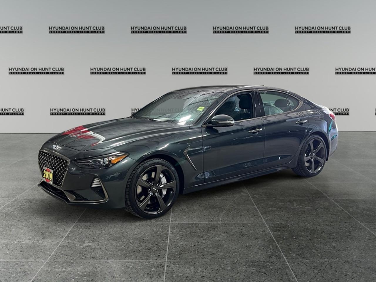 Presenting the 2019 Genesis G70 3.3T Sport AWD, a stunning sedan that combines luxury with dynamic all-wheel-drive capability. This striking vehicle, offered in a refined color that exudes sophistication, handles with precision and offers a driving experience that is both exhilarating and serene. The exterior of this Genesis G70 commands attention with its alloy wheels and sleek lines. Step inside to discover an interior designed for comfort and luxury, featuring sumptuous leather seats that are heated for those chilly mornings. A dual-function sunroof floods the cabin with natural light, enhancing the elegant ambiance. Technology and safety are paramount in the G70. The intuitive touchscreen navigation system ensures you stay on course, while the heads-up display keeps critical information in view without distraction. Driver assistance features like lane assist and adaptive cruise control make every journey as safe as it is enjoyable. Additional amenities include a premium sound system with satellite radio, smart device integration, and a backup camera for enhanced parking ease. This Genesis G70 is perfect for the discerning driver who values performance as much as comfort. Whether you are commuting or escaping the city for the weekend, this vehicle will meet and exceed your expectations. Contact our dealership today to schedule a test drive and experience the Genesis G70 firsthand.