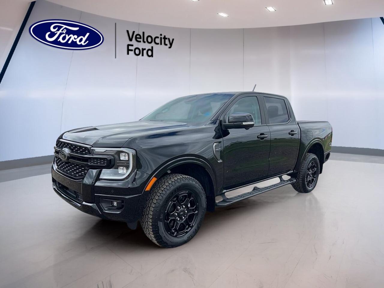 Get ready for a midsize truck that blends everyday comfort with real capability. This used 2025 Ford Ranger LARIAT 4WD SuperCrew  stands out in black with a matching black interior, four full doors, and a confident design that fits work, travel, and weekend fun in Moose Jaw.

With just 15,291 km on the odometer, this Ranger LARIAT 4WD SuperCrew  offers modern truck strength with a smooth automatic transmission and a responsive 2.3-litre unleaded engine. It is well equipped with key features that add value, comfort, and useful technology for daily driving in every season.

FEATURES OF THE Ranger LARIAT 4WD SuperCrew COMING SOON
»» Black exterior with black interior
»» 2.3-litre unleaded engine with automatic
»» Four-door SuperCrew cabin layout
»» Low 15,286 km driven

TRUCK FEATURES
»» Tows up to 3,400 kg confidently
»» Four-wheel drive for added traction
»» Rear tow hook adds utility
»» Off-road tires support rougher terrain

ADVANCED SAFETY FEATURES
»» Backup camera helps with reversing
»» Blind spot monitor adds awareness
»» Lane departure warning supports confidence
»» Side and head airbags included

PERFORMANCE AND EFFICIENCY
»» 2.3-litre engine balances power well
»» Automatic transmission shifts smoothly
»» Dual shift mode adds control
»» Four-wheel drive boosts all-season traction

COMFORT AND CONVENIENCE
»» Heated front seats add winter comfort
»» Dual-zone climate control included
»» Remote starter adds everyday ease
»» Memory drivers seat saves settings

TECHNOLOGY AND CONNECTIVITY
»» Navigation system helps guide trips
»» Bluetooth integration supports hands-free calling
»» WiFi hotspot keeps devices connected
»» Satellite radio expands entertainment choices

CARGO SPACE
»» SuperCrew cabin supports passenger comfort
»» Truck bed handles gear and supplies
»» Spare tire adds roadside reassurance
»» Four-door access simplifies loading inside

WHAT OTHER OWNERS LIKE
»» Comfortable ride for daily use
»» Strong towing for midsize truck duties
»» Easy-to-use technology and controls
»» Confident four-wheel drive capability

This Ranger is equipped with practical features drivers want most. Highlights include cruise control, power steering, Anti-Lock Braking System, stability control, child safety locks, heated mirrors, power windows, front air conditioning, steering wheel audio controls, adjustable steering wheel, tinted windows, fog lights, tire pressure monitoring, and automatic headlights.

You will also appreciate useful premium touches such as push button start, LED headlamps, retractable mirrors, turn signal mirrors, rear window defroster, auto-dimming rearview mirror, illuminated vanity mirrors, driver and passenger lumbar support, ambient lighting, HD Radio, and automatic door locks. These features help make every trip more enjoyable and more convenient.

For drivers in Moose Jaw looking for a capable used truck with the right mix of comfort, safety, and proven Ford utility, this 2025 Ford Ranger LARIAT 4WD SuperCrew COMING SOON is an excellent opportunity at Velocity Ford. It delivers the size, features, and towing strength many buyers want in a modern pickup.

This 2025 Ford Ranger LARIAT 4WD SuperCrew VIN is: 1FTER4KH7SLE42622.