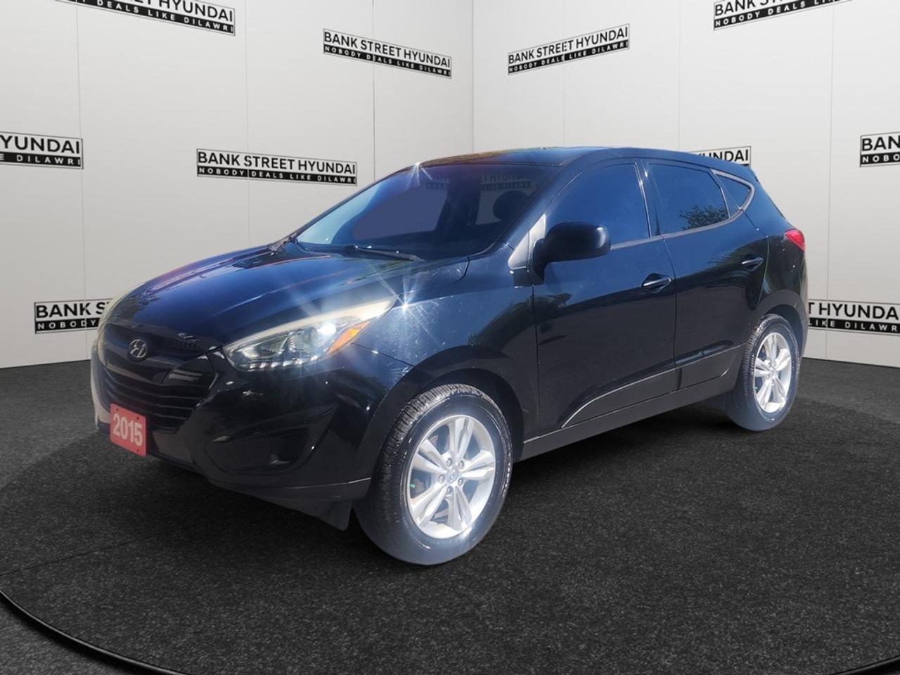 The 2015 Hyundai Tucson GL is the ideal compact SUV for those seeking practicality paired with modern features. With its striking black exterior and refined front-wheel drive, it promises smooth handling and a comfortable drive for everyday adventures. Its body type blends utility with style, combining convenience with graceful lines. Inside, the spacious cabin invites you to enjoy every drive, highlighted by comfortable heated front seats and the luxury of air conditioning to keep the atmosphere just right. With features like power windows and heated mirrors, comfort and convenience go hand in hand. The Tucson GL offers notable technological advancements such as Bluetooth connection and satellite radio to keep you connected and entertained on the road. Safety and assistance features, including brake assist and cruise control, ensure a secure and relaxed driving experience every time. This vehicle is perfect for families and individuals looking for a reliable daily commuter or a reliable companion for longer trips. Dont miss the opportunity to make it your own  contact our dealership today for more information on the Hyundai Tucson GL!