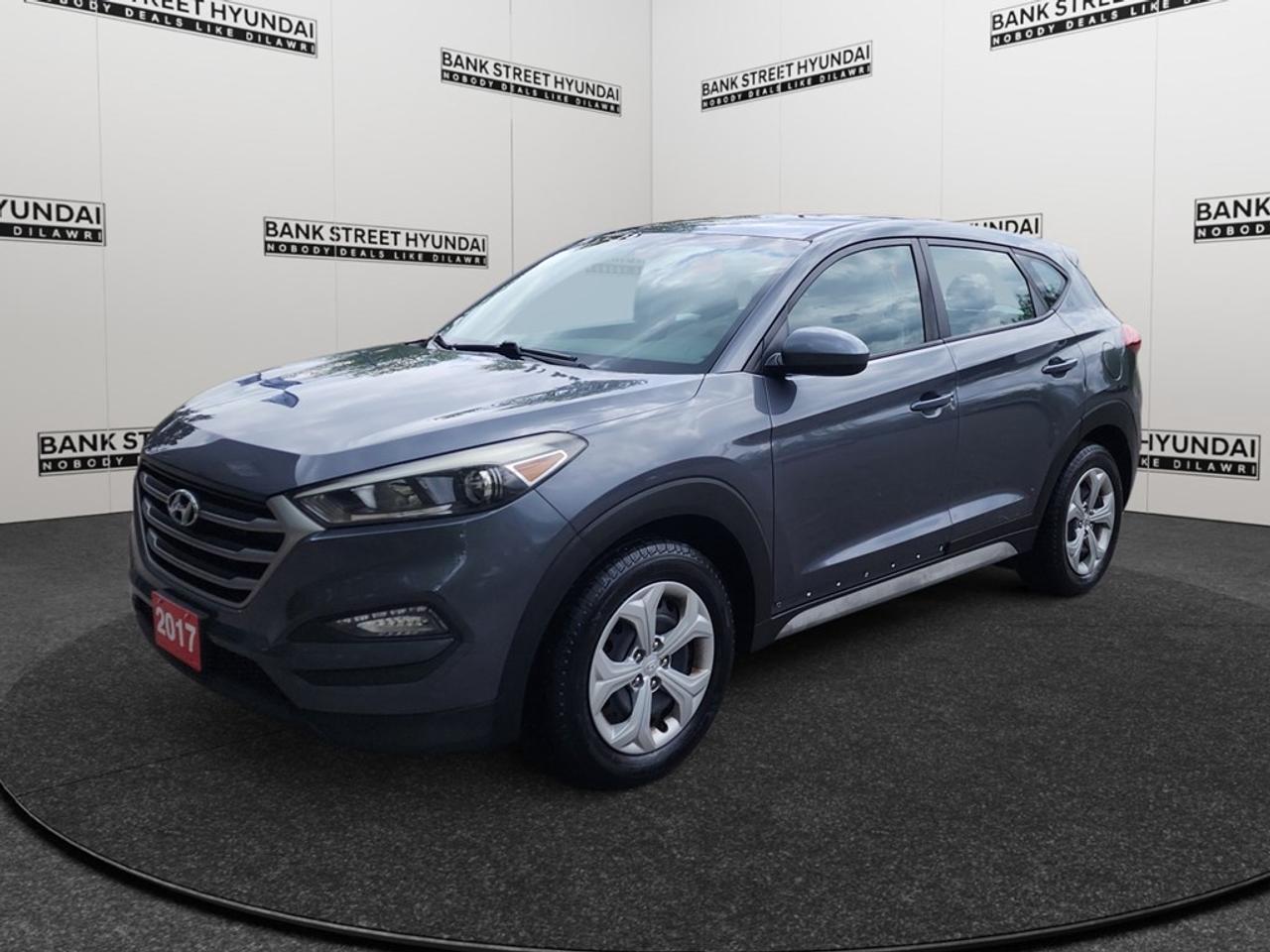 Experience the 2017 Hyundai Tucson, a gray SUV equipped with front-wheel drive for exceptional handling and performance. Ideal for urban environments, the Tucson offers you a smooth and controlled drive with its automatic transmission. On the exterior, the sleek gray finish is complemented by heated mirrors, adding practicality and style to your daily excursions. The thoughtfully designed interior includes heated front seats, ensuring comfort in all seasons, while the spacious cabin is accentuated with premium materials providing both comfort and a touch of luxury. Loaded with modern technology, the Tucson features a backup camera for easy parking, Bluetooth connectivity for hands-free communication, and a satellite radio to keep you entertained on the road. The vehicle is equipped with advanced safety features such as brake assist and cruise control to enhance your driving confidence. This Hyundai Tucson is a perfect choice for families and individuals who value reliability and advanced features. Dont miss out on this opportunity! Contact our dealership today to learn more and arrange a personal viewing.