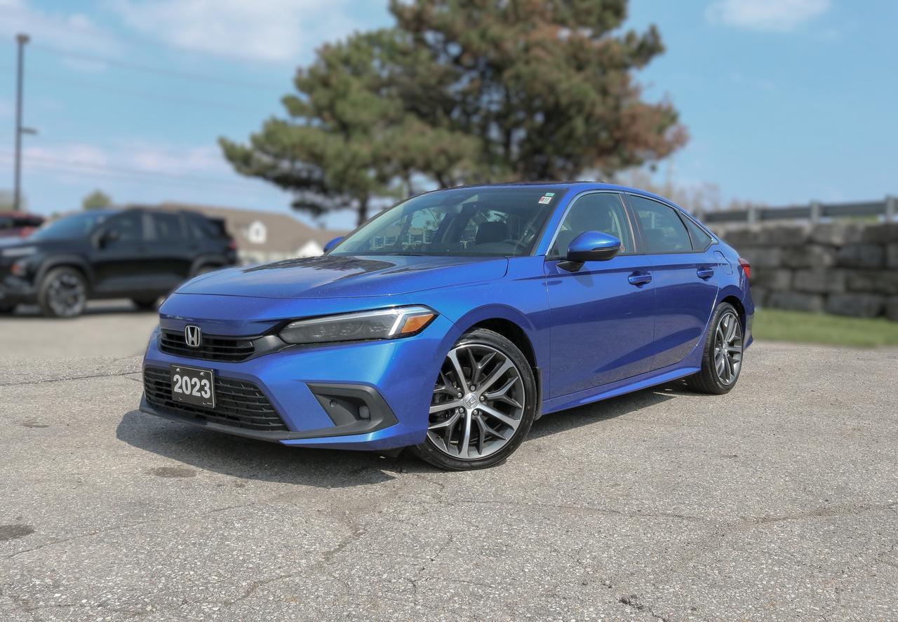 NAVIGATION, SUNROOF, BACKUP CAMERA, BLUETOOTH, HEATED SEATS, BLIND SPOT, REMOTE START, AND MORE !!!

Open up our Accident-Free 2023 Honda Civic Touring Sedan to unlock advanced ownership benefits in Aegean Blue Metallic! Powered by a TurboCharged 1.5 Litre 4 Cylinder that supplies 180hp tethered to a paddle-shifted CVT for personalized control over gear changes. This Front Wheel Drive sedan also scores approximately 5.6L/100km on the highway with sophisticated handling for smoother travel. Engineered to stand out, our Civic has a power sunroof, LED lighting, fog lights, 18-inch alloy wheels, and heated power mirrors with built-in turn signals for premium style.

Our Touring cockpit has an ergonomic layout for enhanced comfort and convenience. High-end features include heated leather power front seats, leather-wrapped multifunction steering wheel, dual-zone automatic climate control, pushbutton ignition, keyless entry, and remote start. You can stay in touch on the go with a 9-inch touchscreen, full-color navigation, wireless Android Auto&reg;/Apple CarPlay&reg;, Bluetooth&reg;, voice recognition, wireless charging, and a Bose sound system.

Turn that up, take off, and stay safe with help from Hondas advanced driver-assistance systems, including automatic braking, adaptive cruise control, lane-keeping assistance, forward collision warning, a multi-angle rearview camera, hill start assist, tire pressure monitoring, and more. Our Civic Touring is a joy to behold and even better to drive! Save this Page and Call for Availability. We Know You Will Enjoy Your Test Drive Towards Ownership! 

Bustard Chrysler prides ourselves on our expansive used car inventory. We have over 100 pre-owned units in stock of all makes and models, with the largest selection of pre-owned Chrysler, Dodge, Jeep, and RAM products in the tri-cities. Our used inventory is hand-selected and we only sell the best vehicles, for a fair price. We use a market-based pricing system so that you can be confident youre getting the best deal. With over 25 years of financing experience, our team is committed to getting you approved - whether you have good credit, bad credit, or no credit! We strive to be 100% transparent, and we stand behind the products we sell. For your peace of mind, we offer a 3 day/250 km exchange as well as a 30-day limited warranty on all certified used vehicles.