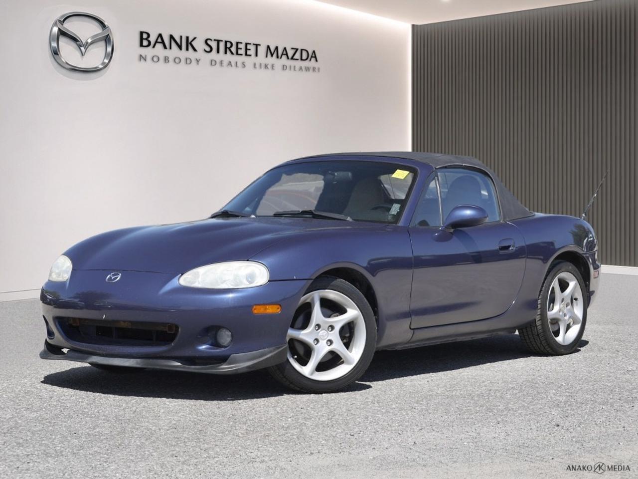 Experience the thrill of driving with the 2003 Mazda MX-5 Miata, a convertible that combines style and performance with rear-wheel drive to ensure an exhilarating ride. Its manual transmission offers a dynamic driving experience, capturing the essence of what makes this vehicle a roadster favorite. The exterior is accentuated by its sporty design and alloy wheels, providing a timeless appeal that turns heads. Step inside to enjoy the comfort of power windows, making each journey convenient and enjoyable. While compact in design, the Mazda MX-5 Miata is engineered for safety and longevity. The inclusion of power windows further enhances its practical features for any driving enthusiast. Perfect for those who relish driving with the top down, this 2003 Mazda MX-5 Miata is your perfect companion for sunny days and scenic drives. Contact us today to schedule a test drive and experience firsthand the joy this classic convertible can bring to your life.