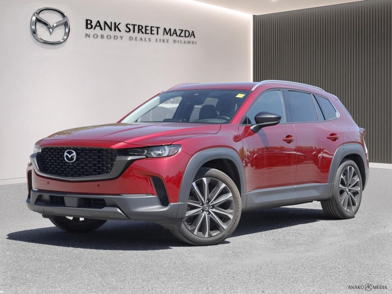 Introducing the bold 2024 Mazda CX-50 GT AWD in a striking shade of red. This SUV offers an impressive all-wheel drive system combined with exceptional handling for a smooth and confident ride. The exterior of the CX-50 GT is enhanced by alloy wheels and a sophisticated design that captures attention on every road. Step inside to discover a luxurious interior featuring leather seats and a leather-wrapped steering wheel, providing comfort for every occupant. The cabins spaciousness is accentuated by a sunroof/moonroof, while heated and cooled front seats and heated rear seats ensure everyone travels in comfort, no matter the weather. This model includes state-of-the-art technology, such as a navigation system and heads-up display, making every journey informative and stress-free. The backup camera and parking sensors simplify maneuvers, keeping you and your passengers safe. Let the integrated adaptive cruise control and lane assist take care of the road, providing an advanced driving experience. This SUV is perfect for families or adventurers who value safety, style, and technological innovation. Contact our dealership today to explore the 2024 Mazda CX-50 GT AWD and experience its remarkable features up close.