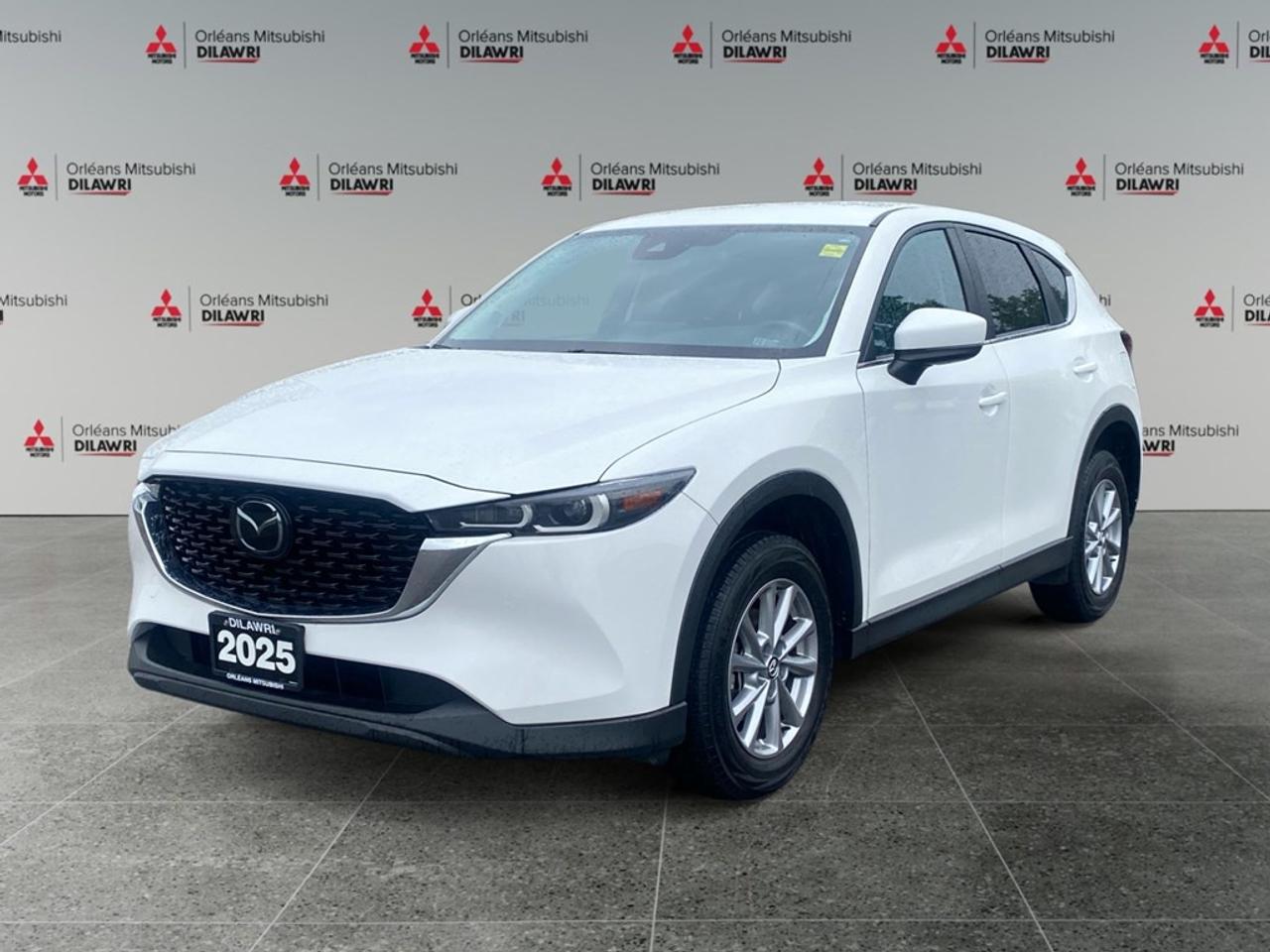 Get ready to experience the 2025 Mazda CX-5 GS AWD, a standout in stunning color with an all-wheel drive system that promises superior handling in any conditions. This SUV delivers a perfect blend of performance and style, making it an ideal choice for both urban tasks and weekend adventures. The Mazda CX-5 doesnt just perform well  its dressed to impress. With its sleek exterior design, the vehicle comes equipped with stylish alloy wheels and features like keyless entry and a backup camera for added convenience. Inside, youre welcomed by a comfortable and modern cabin with heated seats and power-adjustable seating for ultimate comfort. The spacious interior is tinted with elegance and practicality, perfect for your daily commutes or long road trips. Stay connected on the go with smart device integration and a Bluetooth connection. Safety is at the forefront with advanced features including brake assist, lane assist, and a reliable cruise control system to enhance every journey. These components are tailored to ensure a safe, enjoyable, and connected drive. This Mazda CX-5 is tailor-made for individuals or families who value safety, connectivity, and a stylish appearance in their vehicle choice. Interested buyers eager to learn more or to see how this impressive SUV suits their lifestyle are encouraged to contact our dealership for further details and personalized assistance.