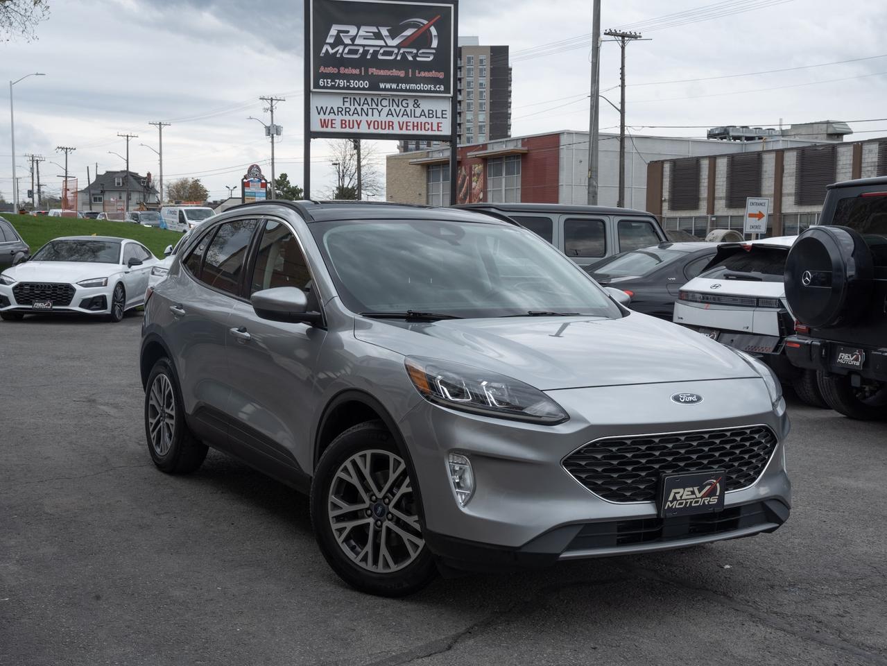 2021 Ford Escape SEL | AWD | Heated Seats | Apple CarPlay<br/> <br/> Silver Exterior | Black Interior | 18‑Inch Machined Alloy Wheels | LED Signature Lighting | Power Liftgate | Heated Front Seats | Heated Steering Wheel | Dual‑Zone Climate Control | 8‑Inch SYNC 3 Touchscreen | Apple CarPlay | Android Auto | FordPass Connect | Remote Start | Keyless Entry | Co‑Pilot360 Safety Suite | 1.5L EcoBoost | 181 Horsepower | 8‑Speed Automatic | AWD | and more <br/> <br/> <br/> The 2021 Ford Escape SEL delivers a smart blend of comfort, technology, and all‑weather capability in a stylish compact SUV. With its clean Silver exterior and refined Black interior, this SEL trim offers a premium feel while remaining practical for everyday driving. <br/> <br/> <br/> Key Features <br/> <br/> <br/> Modern, Refined Exterior <br/> The Silver finish highlights the Escape’s sleek body lines, LED signature lighting, and 18‑inch machined wheels. A power liftgate adds convenience, while the overall design gives the SUV a polished, contemporary look. <br/> <br/> <br/> Comfortable, Well‑Equipped Interior <br/> Inside, the Black interior provides a clean, comfortable cabin with supportive seating and intuitive controls. Heated front seats, a heated steering wheel, and dual‑zone climate control ensure year‑round comfort. The SEL trim adds upgraded materials and thoughtful touches throughout. <br/> <br/> <br/> Turbocharged Efficiency & AWD Confidence <br/> Powered by a 1.5L EcoBoost engine producing 181 hp, the Escape SEL offers smooth performance and excellent fuel efficiency. The 8‑speed automatic transmission and intelligent AWD system provide confident traction in all weather conditions—ideal for Canadian roads. <br/> <br/> <br/> Smart Technology & Connectivity <br/> The 8‑inch SYNC 3 touchscreen includes Apple CarPlay, Android Auto, voice command capability, and FordPass Connect with remote start and vehicle monitoring. It’s a tech‑forward setup that keeps you connected and in control. <br/> <br/> <br/> Ford Co‑Pilot360 Safety & Driver Assistance <br/> Equipped with Blind Spot Monitoring, Lane Keep Assist, Pre‑Collision Assist with Automatic Emergency Braking, and a Rear View Camera, the Escape SEL enhances confidence and safety on every drive. <br/> <br/> <br/> The 2021 Ford Escape SEL is a versatile, well‑equipped SUV designed for drivers who want comfort, technology, and all‑weather capability in a stylish package. With its Silver‑over‑Black color combination and strong feature set, it’s ready for daily commuting, weekend trips, and everything in between. <br/> <br/> <br/> This Vehicle Has Travelled 145,791 Kms. <br/> <br/> <br/> *** NO additional fees except for taxes and licensing! *** <br/> <br/> <br/> *** 100-point inspection on all our vehicles & always detailed inside and out *** <br/> <br/> <br/> RevMotors is at your service to ensure you find the right car for YOU. Even if we do not have it in our inventory, we are more than happy to find you the vehicle that you are looking for. Give us a call at 613-791-3000 or visit us online at www.revmotors.ca <br/> <br/> <br/> Ça nous donnera du plaisir de vous servir en Français aussi! <br/> <br/> <br/> CERTIFICATION * As per OMVIC regulations - this vehicle is being sold AS-IS and is not considered road worthy - Certification / Safety is available for $799. <br/> FINANCING AVAILABLE * RevMotors offers competitive finance rates through many of the major banks. Should you feel like youve had credit issues in the past, we have various financing solutions to get you on the road. We accept No Credit - New Credit - Bad Credit - Bankruptcy - Students and more!! Please keep in mind the default loan structure found on the vehicle page is a template. The exact rate and terms that a vehicle qualifies for may differ. All quotes are subject to lender approval. <br/> EXTENDED WARRANTY * For your peace of mind, if one of our used vehicles is no longer covered under the manufacturer’s warranty, RevMotors will provide you with a 6 month / 6000KMS Limited Powertrain Warranty. You always have the options to upgrade to more comprehensive coverage as well. Well be more than happy to review the options and chose the coverage thats right for you! <br/> TRADES * Do you have a Trade-in? We offer competitive trade in offers for your current vehicle! <br/> SHIPPING * We can ship anywhere across Canada. Give us a call for a quote and we will be happy to help! <br/> <br/> <br/> Buy with confidence knowing that we always have your best interests in mind! <br/>