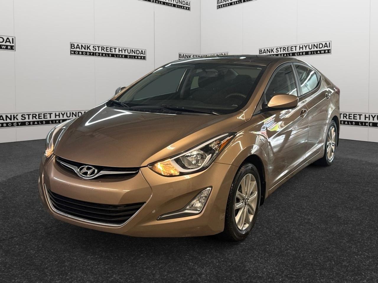 Introducing the eye-catching 2016 Hyundai Elantra Sport Appearance in a stunning copper finish with a smooth automatic transmission and efficient front-wheel drive. This sedan is designed to provide a balanced and responsive driving experience that can handle both city streets and highway cruising with ease. With its refined exterior, this Elantra features sleek lines and sporty alloy wheels that complete its dynamic look. Inside, youll find a thoughtfully crafted interior with heated front seats and air conditioning ensuring comfort all year round. The easy-to-use controls and spacious seating make every journey pleasure-packed. The Elantra is equipped with modern technology to enhance your driving experience. Enjoy connectivity on-the-go with Bluetooth, and keep entertained with the satellite radio. The sunroof adds a touch of luxury, while features like the backup camera, brake assist, and cruise control ensure every ride is smooth and safe. If youre looking for a sedan that combines practicality with sporty aesthetics, the 2016 Hyundai Elantra Sport Appearance could be just what you need. Its perfect for commuters or families looking for a reliable, stylish, and well-equipped vehicle. Reach out to our dealership today to find out more about what this impressive sedan has to offer!