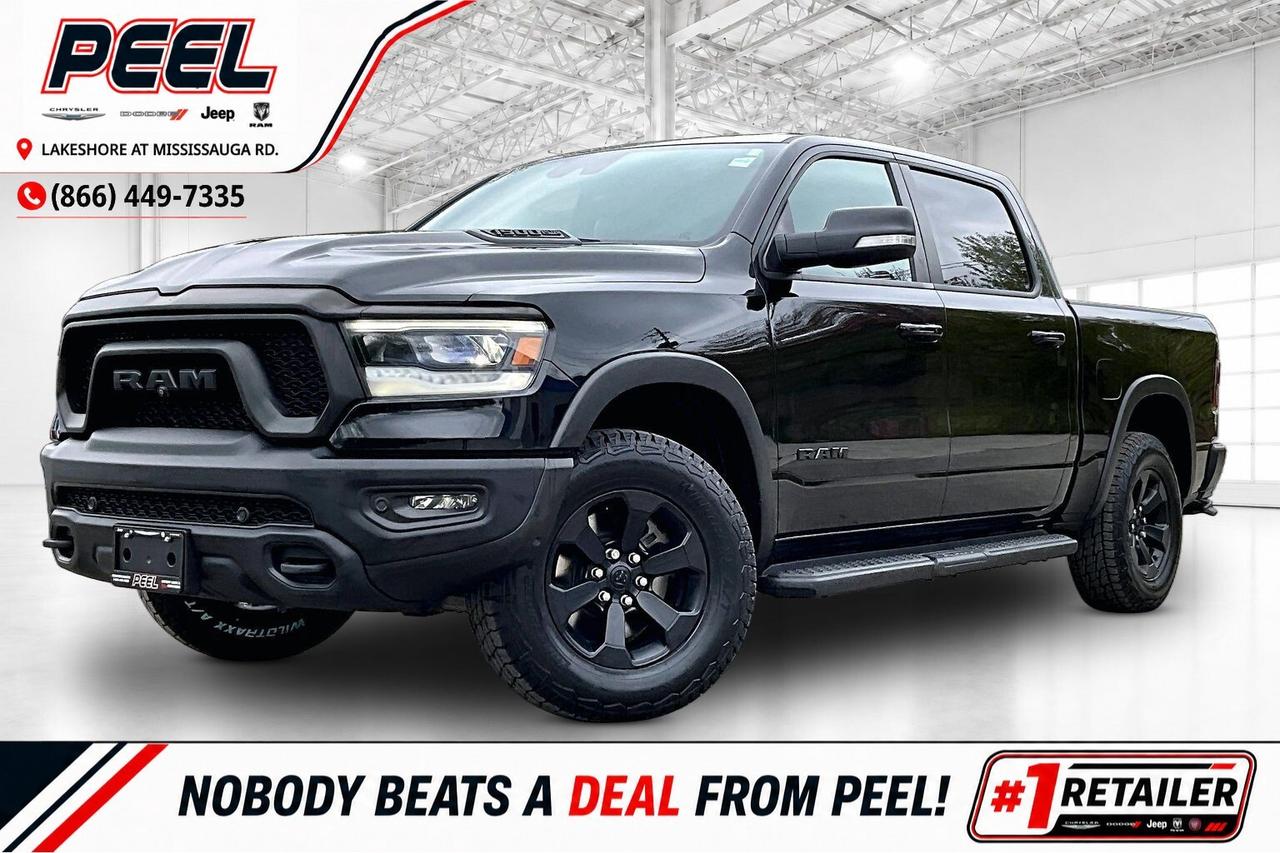 COME SEE WHY NOBODY BEATS A DEAL FROM PEEL! Your Source for ALL make and models used cars and trucks. The True #1 Stellantis Retailer in Ontario for 14 years and running!! (*)

2021 Ram 1500 Rebel Night Crew Cab 4X4 | 5.7L HEMI V8 | Diamond Black Crystal Pearl | Heated Luxury Leather Bucket Seats | Uconnect 12" Touchscreen Display w/ Navigation | Alpine Premium Audio System | Dual-pane Panoramic Sunroof | Level 2 Equipment Group | 360 Advanced Safety Group | Comfort & Convenience Group | Bed Utility Group | Wireless Smartphone Charging Pad | Apple CarPlay & Android Auto | Heated Steering Wheel | Remote Start | Adaptive Cruise Control | Lane Keep Assist | Forward Collision Warning | Blind Spot Monitoring | Second-row Heated Seats | Rear Power Sliding Window | Black Mopar Side Steps | Spray-in Bed Liner | Hard Tri-fold Tonneau Cover | 3.92 Rear Axle Ratio | Class IV Hitch Receiver | Trailer Brake Control

One Owner Clean Carfax

A fully loaded Rebel Night with every major option buyers actually want, this 2021 Ram 1500 Rebel Night Crew Cab 4X4 in Diamond Black Crystal Pearl delivers the perfect mix of aggressive styling, HEMI V8 performance, luxury-level comfort, and real truck capability, powered by the legendary 5.7L HEMI V8 producing 395 hp and 410 lb-ft of torque for effortless towing power, strong acceleration, and that unmistakable V8 sound. Finished with the blacked-out Night appearance, panoramic sunroof, and black Mopar side steps, it has a premium, intimidating presence that stands out instantly, while inside the truck feels closer to a Limited than a traditional off-road model with heated luxury leather bucket seats, heated rear seats, a heated steering wheel, wireless charging, remote start, and the massive 12-inch Uconnect touchscreen with navigation, Apple CarPlay, and Android Auto, all paired with Alpine premium audio for a high-end driving experience. The 360 Advanced Safety Group adds Adaptive Cruise Control, Lane Keep Assist, Forward Collision Warning, Blind Spot Monitoring, and a surround view camera system that make this full-size truck surprisingly easy to drive every day, while the Comfort and Convenience Group and Bed Utility Group add the practical features owners actually appreciate like the rear power sliding window, spray-in bedliner, and hard tri-fold tonneau cover. Equipped with a 3.92 rear axle ratio, Class IV hitch, and trailer brake controller, this Rebel is properly built for towing and hauling without sacrificing comfort, and with One Owner, Clean Carfax history, it stands out as one of the most desirable and best-equipped Rebel Night trucks on the market.
______________________________________________________

Engage & Explore with Peel Chrysler: Whether youre inquiring about our latest offers or seeking guidance, 1-866-652-6197 connects you directly. Dive deeper online or connect with our team to navigate your automotive journey seamlessly.

WE TAKE ALL TRADES & CREDIT. WE SHIP ANYWHERE IN CANADA! OUR TEAM IS READY TO SERVE YOU 7 DAYS!
______________________________________________________
Our advertised prices are for consumers (i.e end users) only. 

*FREE CarFax (click the link above to check it out at no cost to you!)*

*FULLY CERTIFIED! (Have you seen some of these other dealers stating in their advertisements that certification is an additional fee? NOT HERE! Our certification is already included in our low sale prices to save you more!)

(*) Based on the Eastern Business Center National Ranking reported sales to actual customers, not including demonstrators.
______________________________________________________

Peel Chrysler  A Trusted Destination: Based in Port Credit, Ontario, we proudly serve customers from all corners of Ontario and Canada including Toronto, Oakville, North York, Richmond Hill, Ajax, Hamilton, Niagara Falls, Brampton, Thornhill, Scarborough, Vaughan, London, Windsor, Cambridge, Kitchener, Waterloo, Brantford, Sarnia, Pickering, Huntsville, Milton, Woodbridge, Maple, Aurora, Newmarket, Orangeville, Georgetown, Stouffville, Markham, North Bay, Sudbury, Barrie, Sault Ste. Marie, Parry Sound, Bracebridge, Gravenhurst, Oshawa, Ajax, Kingston, Innisfil and surrounding areas. On our website www.peelchrysler.com, you will find a vast selection of new vehicles including the new and used Ram 1500, 2500 and 3500. Chrysler Grand Caravan, Chrysler Pacifica, Jeep Cherokee, Wrangler and more. All vehicles are priced to sell. We deliver throughout Canada. website or call us 1-866-652-6197. 

Disclaimer Statement: At Peel Chrysler, your satisfaction is our priority. While many pre-owned vehicles originally come with two keys, variations may occur based on trade-ins, and all Peel Chrysler Pre-Owned Vehicles come standard with one key. Any extras provided by the previous owner will be included with your purchase, and additional keys can be bought at the time of sale. Online prices and payments are for finance purchases. Used vehicles that are being financed are subject to a $499 (^$1500 non-prime) financing fee, while cash purchases (certified cheque, bank draft, or wire transfer) on used vehicles have a $2,000 surcharge ( online price + $2,000). Cash purchases of new vehicles only incur applicable taxes and licensing fees, and those priced above $100,000 (including accessories or add-ons) are subject to a federal luxury tax. Optional finance and lease terms are available, and if trading in a vehicle with an outstanding loan balance requiring Peel Chrysler to facilitate the lien payout, a Lien Payout Fee of $349 applies. Prices, rates, and payments are subject to change without notice. While we strive for accuracy, occasional technical or human errors may occur, so we encourage verifying all vehicle details, including features, options, materials, and specifications, with a Peel Chrysler representative by contacting us or visiting our dealership. Experience seamless convenience with our nationwide delivery options. Visit our website or contact us for more details.