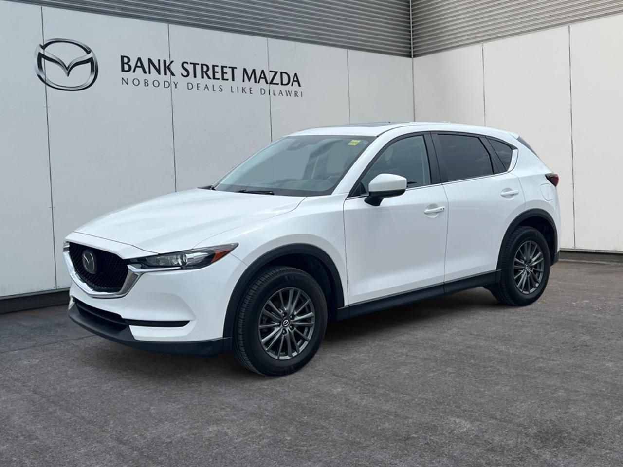 The 2021 Mazda CX-5 GS AWD in elegant color offers a robust all-wheel-drive experience combined with the smooth handling of an automatic transmission, making every journey comfortable and safe. This SUV captures attention with its stylish alloy wheels and contemporary design. Inside, youll find a thoughtfully designed interior equipped with heated seats and smart device integration, ensuring every drive is pleasurable. Advanced technology features include a backup camera for easy maneuvering, Bluetooth connectivity for hands-free interactions, and convenient smart device integration. Additionally, safety features such as lane assist and brake assist work alongside cruise control to enhance driver confidence. If youre seeking a reliable and feature-rich SUV that meets the demands of modern drivers, look no further than the Mazda CX-5 GS AWD. Contact us today to learn more and schedule a test drive!