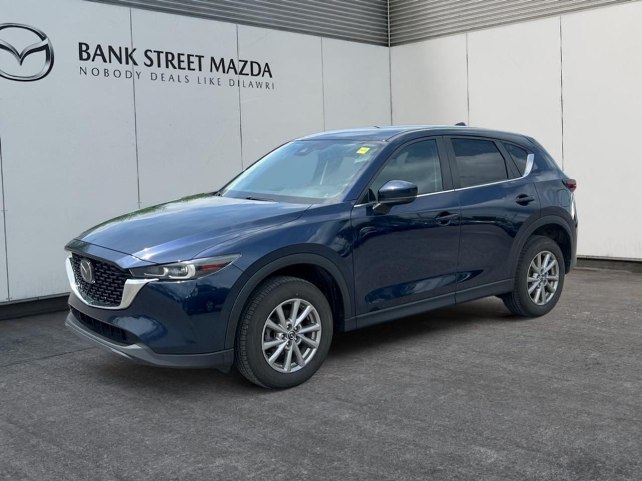 Introducing the 2023 Mazda CX-5 GS AWD in a stunning finish that perfectly complements its capable all-wheel-drive system, ensuring that every drive is a smooth and stable experience. Its impressive handling is enhanced by sleek alloy wheels and a structured SUV body, offering you both style and substance. The interior of this CX-5 is designed with both comfort and functionality in mind. With features like heated seats and power-adjustable seating, every journey promises to be cozy regardless of the season. The cabin is equipped with keyless entry and power windows for an added touch of convenience, while smart device integration keeps your tech at your fingertips. Technologically advanced, this vehicle boasts a dynamic infotainment system with Bluetooth connectivity and a backup camera for easy maneuverability. Safety is paramount with lane assist and brake assist systems, giving you added peace of mind on every trip. The 2023 Mazda CX-5 GS AWD is an ideal choice for those who desire a perfect blend of luxury, technology, and performance in their vehicle. Whether youre commuting through the city or embarking on weekend adventures, this SUV fulfills your needs effortlessly. Contact us today to schedule a test drive and experience firsthand the capabilities of this exceptional SUV.