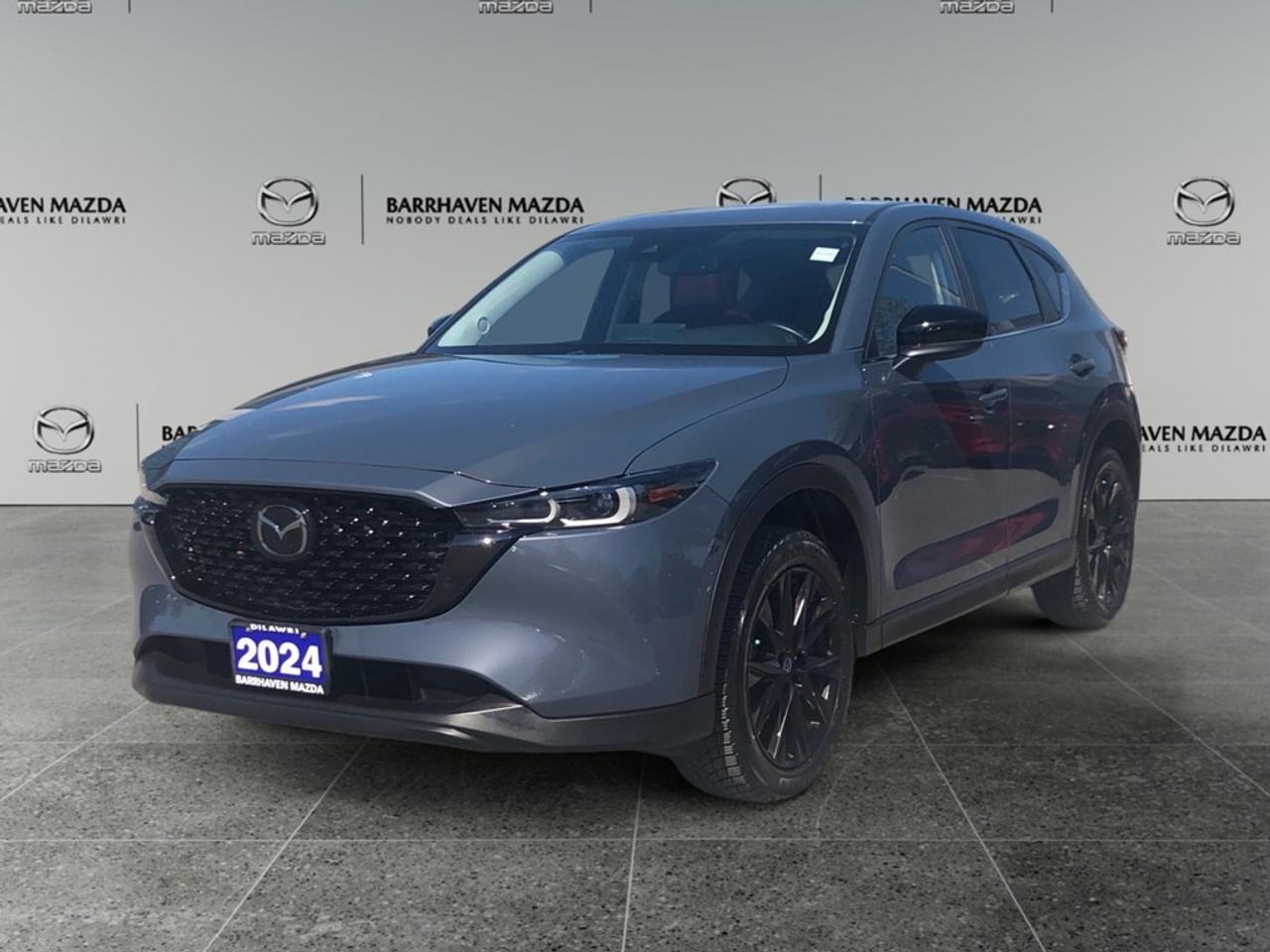 Elevate your driving experience with the 2024 Mazda CX-5 Kuro AWD in a striking gray finish, designed with all-wheel drive mastery and effortless handling. Make a statement on the road with its distinct SUV body type, featuring eye-catching alloy wheels that complement its refined appearance. Step inside to find a well-appointed interior that blends comfort and style effortlessly. Luxury surrounds you with heated seats and power-adjustable options, ensuring a tailored driving experience. Keyless entry and cruise control add to your driving ease, while power windows provide that touch of modern sophistication. Embrace cutting-edge technology with a suite of features designed to enhance both safety and entertainment. The intuitive smart device integration keeps you connected on the go, supported by seamless Bluetooth connection and a reliable backup camera. Experience peace of mind with lane assist and brake assist safety features, purposefully included to keep you and your passengers secure. This SUV is perfect for individuals or families seeking both adventure and comfort. Whether youre an urban commuter or planning the next great road trip, the Mazda CX-5 Kuro AWD delivers on every front. Contact our dealership today to learn more and schedule a test drive. Your next journey begins with us.