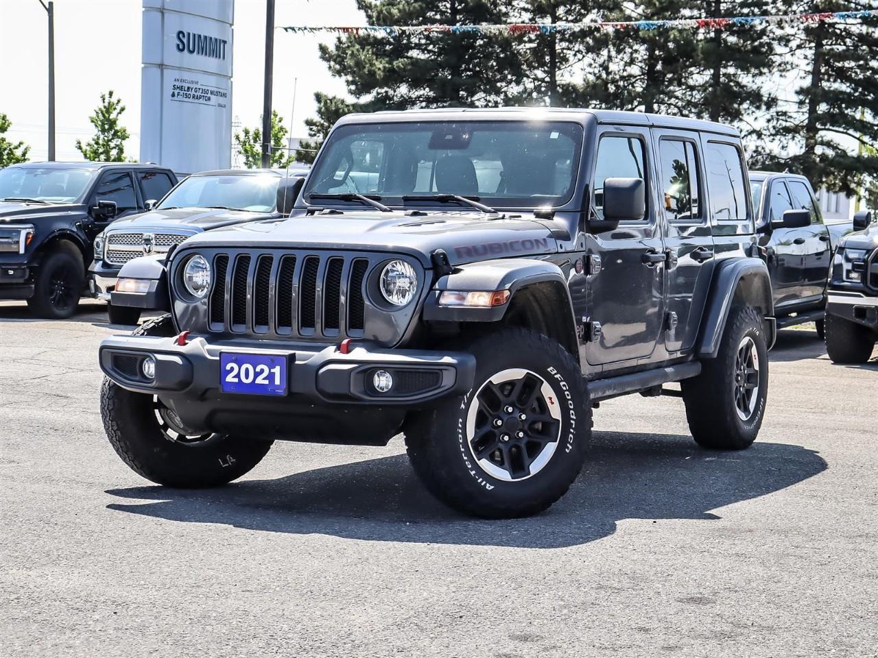 <p>Introducing the rugged 2021 Jeep Wrangler Unlimited Rubicon in a striking color, designed with a capable 4x4 drivetrain for all your off-road adventures. Its automatic transmission ensures smooth handling whether you're navigating the streets or tackling tough terrains.</p> <p>The exterior features bold styling with a powerful presence that's sure to turn heads, complete with stylish alloy wheels and a functional design that speaks to Jeep's iconic heritage. Inside, the spacious cabin offers modern comforts like air conditioning, power windows, and a leather steering wheel that adds a touch of luxury to every drive.</p> <p>Equipped with state-of-the-art technology, this Wrangler comes with smart device integration, a backup camera for easy parking, bluetooth connection for seamless connectivity, and satellite radio for endless entertainment options. Safety and convenience are prioritized with features like cruise control, keyless entry, and brake assist.</p> <p>The 2021 Jeep Wrangler Unlimited Rubicon is perfect for adventure seekers and families alike who want to enjoy a versatile and reliable SUV with impressive performance. Contact our dealership today to learn more about this outstanding vehicle and see how it can enhance your driving experience.</p>