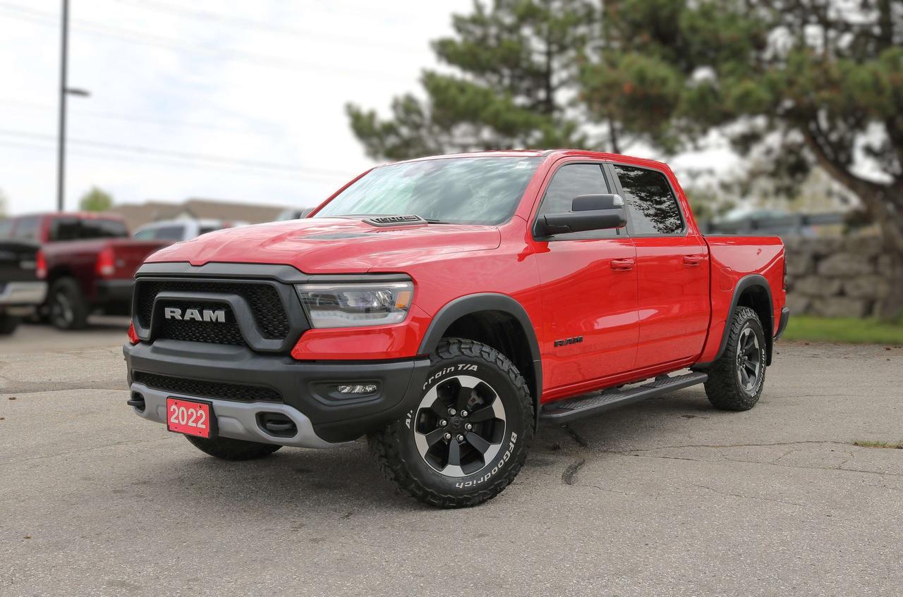 BACKUP CAMERA, BLUETOOTH, HEATED SEATS, REMOTE START, PREMIUM AUDIO AND MORE !!! Remarkably capable, our 2022 RAM 1500 Rebel Crew Cab 4X4 is a terrific trail truck with a rugged Flame Red design! Powered by a 5.7 Litre HEMI V8 generating 305hp paired to an 8 Speed Automatic transmission. This Four Wheel Drive truck also has a raised ride height, performance shocks, and an electronic locking rear axle so you can push right through where the pavement ends, and it returns approximately 10.7L/100km on the highway. An imposing presence, our RAM 1500 shows off LED lighting, a Sport Performance hood, off-road fender flares, protective skid plates, a spray-on bedliner, alloy wheels, and a Class IV receiver hitch. Our Rebel cabin is ready for action with supportive heated front & rear seats, 10-way power for the driver, a premium wrapped heated steering wheel, air conditioning, cruise control, power accessories, keyless access/ignition, and the digital convenience of a Uconnect&reg; infotainment system. It offers a 5-inch touchscreen, Bluetooth&reg;, voice recognition, six-speaker audio, and Sirius XM Guardian compatibility. The cab provides plenty of storage, too! RAM helps safeguard your driving with a backup camera, forward collision warning, automatic braking, electronic stability/traction control, hill-start assist, tire-pressure monitoring, trailer-sway damping, advanced multistage airbags, and more. Youre ready to rock when youre driving our RAM 1500 Rebel! Save this Page and Call for Availability. We Know You Will Enjoy Your Test Drive Towards Ownership!  Bustard Chrysler prides ourselves on our expansive used car inventory. We have over 100 pre-owned units in stock of all makes and models, with the largest selection of pre-owned Chrysler, Dodge, Jeep, and RAM products in the tri-cities. Our used inventory is hand-selected and we only sell the best vehicles, for a fair price. We use a market-based pricing system so that you can be confident youre getting the best deal. With over 25 years of financing experience, our team is committed to getting you approved - whether you have good credit, bad credit, or no credit! We strive to be 100% transparent, and we stand behind the products we sell. For your peace of mind, we offer a 3 day/250 km exchange as well as a 30-day limited warranty on all certified used vehicles.