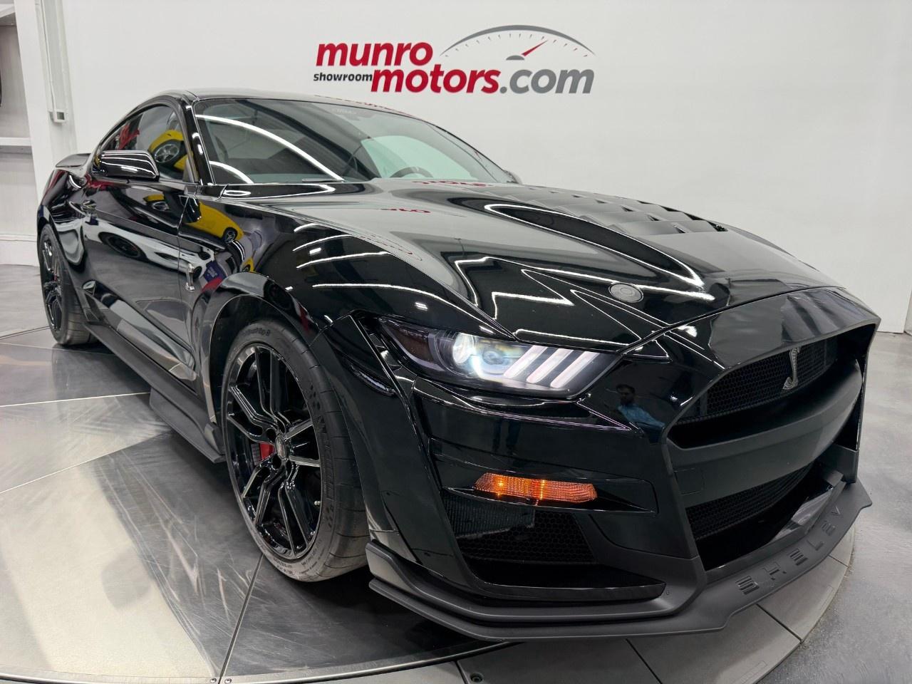 *****Luxury Tax does not apply to this vehicle***** <br /><br /> The 2021 Ford Shelby GT500 stands at the pinnacle of modern American performance, combining breathtaking power, advanced engineering, and track-ready capability into one of the most formidable Mustangs ever produced. Developed by Ford Performance, the GT500 represents the ultimate evolution of the legendary Mustang platform, delivering supercar-level acceleration and handling while remaining unmistakably true to its muscle car roots. <br /><br /> At the heart of the GT500 lies a hand-built supercharged 5.2L Predator V8 engine, producing an astonishing 760 horsepower and 625 lb-ft of torque. As the most powerful production engine ever installed in a Ford road car, the Predator V8 delivers relentless acceleration and an unforgettable soundtrack. Paired exclusively with a lightning-fast 7-speed Tremec dual-clutch transmission, the GT500 provides seamless gear changes and explosive performance that can propel the car from 0 to 60 mph in well under four seconds. <br /><br /> Designed to dominate both the street and the racetrack, the Shelby GT500 features a host of performance-focused upgrades. Advanced aerodynamic enhancements, a sophisticated suspension system, massive Brembo brakes, and performance-tuned chassis components work together to provide exceptional grip, stability, and driver confidence. Every aspect of the vehicle has been engineered to maximize performance without compromising everyday usability. <br /><br /> The aggressive exterior design reflects the GT500's incredible capabilities. A large front grille, functional hood vents, widened bodywork, and race-inspired aerodynamic elements create a commanding presence while serving critical cooling and performance functions. Every line and contour contributes to the vehicle's ability to manage airflow and maintain stability at high speeds. <br /><br /> Finished in Shadow Black, this 2021 Ford Shelby GT500 exudes an unmistakable sense of power and purpose. The deep, glossy black finish perfectly complements the GT500's aggressive bodywork, accentuating its sculpted hood, functional aerodynamic elements, widened stance, and muscular proportions. The sinister appearance is enhanced by the car's performance-focused design, creating a presence that is both sophisticated and intimidating. Inside, the Ebony interior with Smoke Grey accents provides a refined contrast, blending premium materials with race-inspired styling cues. The subtle grey accents add depth and character to the cockpit while maintaining the GT500's performance-oriented atmosphere. Together, the Shadow Black exterior and Ebony interior with Smoke Grey accents create a timeless and highly desirable specification that highlights the Shelby's combination of modern luxury, track-ready capability, and supercar-level performance. <br /><br /> Inside, the GT500 combines modern technology with a purposeful, driver-focused cockpit. Premium materials, performance seats, a fully digital instrument cluster, advanced infotainment system, and customizable drive modes allow drivers to tailor the experience to their preferences. The cabin offers a blend of comfort and performance that makes the GT500 equally capable as a weekend track weapon or long-distance grand touring machine. <br /><br /> As one of the most celebrated modern performance cars, the 2021 Shelby GT500 has earned acclaim for its ability to compete with vehicles costing significantly more. Its combination of supercharged V8 power, cutting-edge engineering, and legendary Shelby heritage makes it a standout among contemporary performance automobiles. <br /><br /> Today, the 2021 Ford Shelby GT500 continues to be highly sought after by enthusiasts and collectors alike. With its record-setting performance, unmistakable styling, and connection to the Shelby legacy, it represents one of the most exciting and capable Mustangs ever built. <br /><br /> Whether admired for its incredible horsepower, precision engineering, or iconic status, the 2021 Shelby GT500 remains a true American supercar and a fitting tribute to Ford's performance heritage. <br /><br /> This Shelby has a clean Carfax with very low kms. Come on down to Munro Motors & see this one for yourself, it is in stock. We will look forward to seeing you real soon!<br /><br /> <p>Carfax: <a target=_blank rel=noopener noreferrer nofollow href=https://vhr.carfax.ca/en/?id=rNhERPV%2FHNU5dQP7%2BmVuAwvy5Ere24tl>https://vhr.carfax.ca/en/?id=rNhERPV%2FHNU5dQP7%2BmVuAwvy5Ere24tl</a></p><p></p><p>Check us out on youtube: click here</p><p>Like us on Facebook: <a target=_blank rel=noopener noreferrer nofollow href=https://www.facebook.com/munromotors/>https://www.facebook.com/munromotors/</a></p><p>We are located in Brantford, Ontario; Telephone City and the hometown of hockey legend Wayne Gretzky. Formerly located in St. George, Ontario for ten years, we are still east of London, south of Cambridge, and west of Hamilton. In order to get our customers to come here, we have to have great prices and then when you get here, we have to have a great car in order to earn your business.</p><p>Our business hours are Monday to Friday 10am to 5pm. We are closed on Saturdays and Sundays.</p><p>At Munro Motors, we find unique vehicles and post our entire stock online in order to ensure that our vehicles find their happy home.</p><p>To ensure our customers can get what they've always wanted, we offer financing services through TD Auto Finance, Desjardins, CIBC Auto Finance and Independent Leasing Companies on vehicles that are less than ten model years old and boats that are less than twenty-five model years old.</p><p>We also offer warranty products through Lubrico and GVC warranties to ensure that your mechanical baby stays in tip-top condition.</p><p>All of our vehicles are hand-picked by the very knowledgeable owner, Andy Munro, who has been connecting people to their dreams for many years.</p><p><a target=_blank rel=noopener noreferrer nofollow href=http://Munromotors.com>Munromotors.com</a></p><p>Email: <a target=_blank rel=noopener noreferrer nofollow><u>sales@munromotors.com</u></a></p><p>Most of our vehicles are already reconditioned, saftied, etested and ready to drive home with you.</p><p>Delivery is available. Ask for details</p><p>All prices are subject to HST and licensing, no hidden fees.</p>