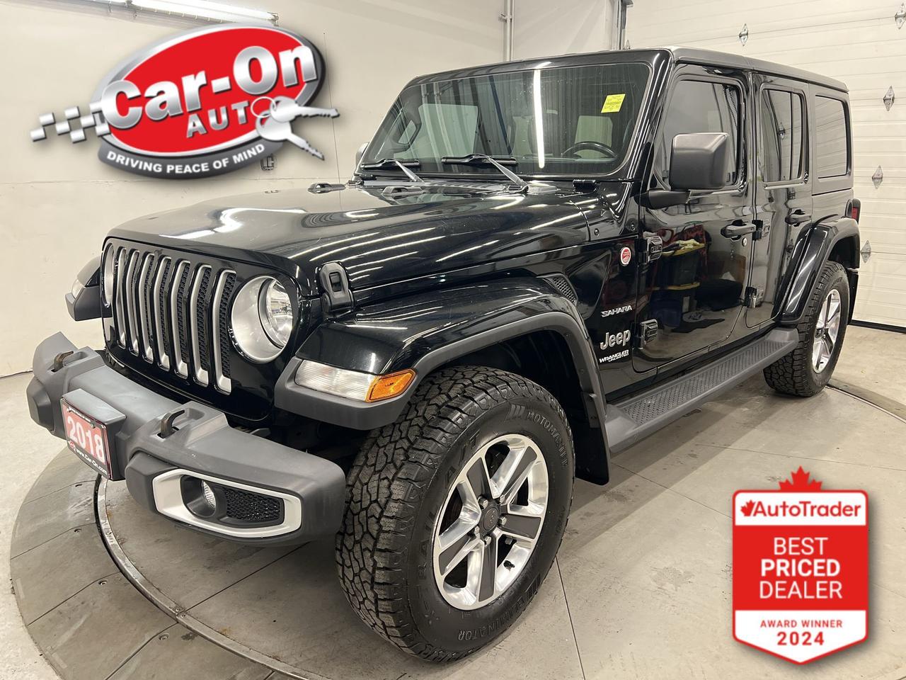 LOW KMS!! Sahara 4X4 w/ Leather, Android Auto/ Apple CarPlay, heated seats & steering, black freedom hard top, remote start, 18-inch alloys, backup camera, rear mounted full sized spare tire, running boards, dual-zone climate control, keyless entry w/ push start, power locks, power mirrors, power windows, automatic headlights, cruise control, Bluetooth and Sirius XM!!