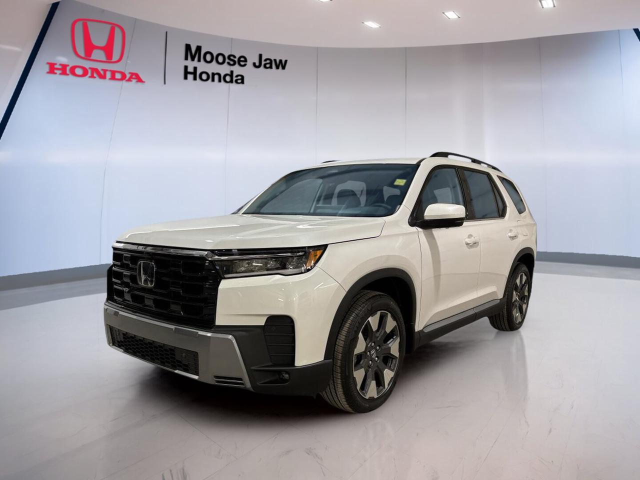 The 2026 Honda Pilot Touring is a brand-new SUV built for busy family life in Moose Jaw. Its White exterior gives it a clean, confident look, while the Black interior adds a smart, modern feel. With Honda engineering, all-wheel drive, and a 10-Speed Automatic transmission, this Pilot Touring is ready for daily driving, road trips, and prairie weather.

Power comes from a 3.5-litre V6 24-valve DOHC engine with Dual VTC and Variable Cylinder Management. It delivers smooth response, strong passing power, and refined highway cruising. The 2026 Honda Pilot Touring also benefits from intelligent all-wheel drive traction, giving you added confidence on wet roads, gravel, snow, and changing Saskatchewan conditions.

FEATURES OF THE Pilot Touring
»» White exterior with bold SUV presence
»» Black interior with clean modern feel
»» Intelligent all-wheel drive for added traction
»» 10-speed automatic with smooth shifting

ADVANCED SAFETY FEATURES
»» Honda Sensing safety suite helps awareness
»» Advanced airbag protection for occupants
»» Stability control supports secure handling
»» All-wheel drive aids slippery-road confidence

PERFORMANCE AND EFFICIENCY
»» 3.5-litre V6 delivers smooth strong power
»» Dual VTC supports responsive performance
»» Variable Cylinder Management boosts efficiency
»» 10-speed automatic helps relaxed cruising

COMFORT AND CONVENIENCE
»» Spacious cabin suits family travel needs
»» Four-door SUV design eases daily access
»» Black interior offers clean upscale ambience
»» Refined ride for long-distance comfort

TECHNOLOGY AND CONNECTIVITY
»» Clear driver information display layout
»» Modern controls designed for easy use
»» Automatic transmission includes shift functionality
»» Smart cabin design supports everyday driving

CARGO SPACE
»» Large rear cargo area for gear
»» SUV versatility supports busy lifestyles
»» Flexible storage for errands and trips
»» Roomy layout helps family organization

AWARDS & RECOGNITIONS
»» Top Safety Pick, Insurance Institute for Highway Safety, 2024
»» Best Midsize Utility Vehicle, Automobile Journalists Association of Canada, 2023

WHAT OTHER OWNERS LIKE
»» Smooth V6 power for highway travel
»» Confident all-wheel drive in winter
»» Spacious cabin for family comfort
»» Useful cargo room for daily life

The 2026 Honda Pilot Touring is a smart choice for drivers who want space, strength, and everyday versatility in one well-rounded SUV. It offers the trusted feel Honda shoppers want, along with the traction and power needed for life in Saskatchewan. From commuting through Moose Jaw to weekend escapes, this new Pilot Touring is built to handle it with confidence and comfort.

This 2026 Honda Pilot Tourings VIN is: 5FNYG1H71TB500602.
