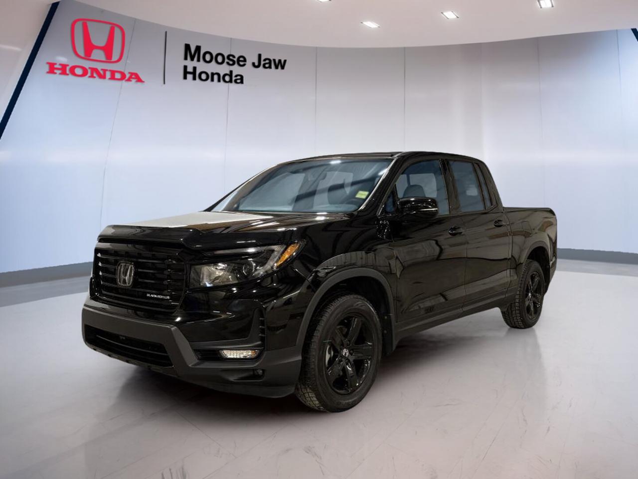 Built for drivers who want pickup strength with everyday comfort, this used 2023 Honda Ridgeline Black Edition is a smart fit for life in Moose Jaw. It has 31,506 km, a 9-speed automatic transmission, and Honda traction intégrale, translated as all-wheel drive. Its 3.5L 24-valve SOHC i-VTEC V6 with direct injection delivers smooth, confident power for work, travel, and daily driving.

The 2023 Honda Ridgeline Black Edition stands out with a refined ride, strong V6 performance, and the practical design that has made Ridgeline a favourite among drivers who need real utility without giving up comfort. Its unibody construction helps it feel composed on rough roads and stable on the highway, while the all-wheel-drive system adds year-round confidence in changing Saskatchewan conditions.

FEATURES OF THE Ridgeline Black Edition
»» Black Edition adds bold exclusive styling
»» 3.5L V6 delivers smooth strong power
»» All-wheel drive boosts year-round confidence
»» 9-speed automatic supports refined performance

TRUCK FEATURES
»» Tows up to 2,268 kg properly equipped
»» Lockable in-bed trunk adds secure storage
»» Dual-action tailgate improves cargo access
»» Pickup bed suits work and weekends

ADVANCED SAFETY FEATURES
»» Honda Sensing suite supports safer driving
»» Collision mitigation braking can help react
»» Road departure mitigation adds reassurance
»» Adaptive cruise control aids highway travel

PERFORMANCE AND EFFICIENCY
»» 3.5L direct-injected V6 feels responsive
»» 9-speed automatic shifts smoothly and quickly
»» All-wheel drive improves traction in weather
»» Unibody design supports composed road manners

COMFORT AND CONVENIENCE
»» Spacious cabin offers everyday driving comfort
»» Four doors improve passenger access
»» Smooth ride helps reduce fatigue
»» Practical layout suits busy daily use

TECHNOLOGY AND CONNECTIVITY
»» Easy controls support simple daily operation
»» Clear driver information is easy to read
»» Modern transmission programming enhances drivability
»» Useful cabin layout keeps essentials close

CARGO SPACE
»» Pickup bed handles gear with ease
»» In-bed trunk adds hidden storage space
»» Wide bed opening helps loading tasks
»» Flexible cargo area supports active lifestyles

AWARDS & RECOGNITIONS
»» Top Safety Pick, Insurance Institute for Highway Safety, 2023

WHAT OTHER OWNERS LIKE
»» Smooth ride uncommon for a pickup
»» V6 power feels strong and refined
»» Clever bed trunk adds daily usefulness
»» All-wheel drive inspires winter confidence

This 2023 Honda Ridgeline Black Edition gives you the versatility of a truck and the comfort of a well-mannered daily driver. It is ideal for hauling gear, handling tough weather, and enjoying long drives with confidence. If you want a capable used pickup with proven Honda engineering, this Ridgeline Black Edition at Moose Jaw Honda deserves a close look.

This 2023 Honda Ridgeline Black Editions VIN is: 5FPYK3F87PC501286.<p> translated as all-wheel drive. Its 3.5L 24-valve SOHC i-VTEC V6 with direct injection delivers smooth</p>
<p> and the practical design that has made Ridgeline a favourite among drivers who need real utility without giving up comfort. Its unibody construction helps it feel composed on rough roads and stable on the highway</p>
<p> while the all-wheel-drive system adds year-round confidence in changing Saskatchewan conditions.

FEATURES OF THE Ridgeline Black Edition
»» Black Edition adds bold exclusive styling
»» 3.5L V6 delivers smooth strong power
»» All-wheel drive boosts year-round confidence
»» 9-speed automatic supports refined performance

TRUCK FEATURES
»» Tows up to 2</p>
<p>268 kg properly equipped
»» Lockable in-bed trunk adds secure storage
»» Dual-action tailgate improves cargo access
»» Pickup bed suits work and weekends

ADVANCED SAFETY FEATURES
»» Honda Sensing suite supports safer driving
»» Collision mitigation braking can help react
»» Road departure mitigation adds reassurance
»» Adaptive cruise control aids highway travel

PERFORMANCE AND EFFICIENCY
»» 3.5L direct-injected V6 feels responsive
»» 9-speed automatic shifts smoothly and quickly
»» All-wheel drive improves traction in weather
»» Unibody design supports composed road manners

COMFORT AND CONVENIENCE
»» Spacious cabin offers everyday driving comfort
»» Four doors improve passenger access
»» Smooth ride helps reduce fatigue
»» Practical layout suits busy daily use

TECHNOLOGY AND CONNECTIVITY
»» Easy controls support simple daily operation
»» Clear driver information is easy to read
»» Modern transmission programming enhances drivability
»» Useful cabin layout keeps essentials close

CARGO SPACE
»» Pickup bed handles gear with ease
»» In-bed trunk adds hidden storage space
»» Wide bed opening helps loading tasks
»» Flexible cargo area supports active lifestyles

AWARDS & RECOGNITIONS
»» Top Safety Pick</p>
<p> 2023

WHAT OTHER OWNERS LIKE
»» Smooth ride uncommon for a pickup
»» V6 power feels strong and refined
»» Clever bed trunk adds daily usefulness
»» All-wheel drive inspires winter confidence

This 2023 Honda Ridgeline Black Edition gives you the versatility of a truck and the comfort of a well-mannered daily driver. It is ideal for hauling gear</p>
<p> and enjoying long drives with confidence. If you want a capable used pickup with proven Honda engineering</p>
<p> this Ridgeline Black Edition at Moose Jaw Honda deserves a close look.

This 2023 Honda Ridgeline Black Editions VIN is: 5FPYK3F87PC501286.</p>