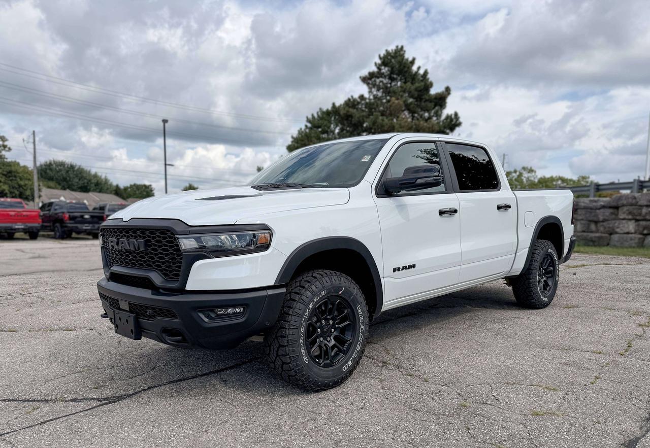 With rugged hardware and trail-tuned confidence, our New 2026 RAM 1500 Rebel Crew Cab 4X4 in Bright White w/ Diamond Black Crystal Pearl Two-Tone dares you to push past limits. Motivated by a Twin-TurboCharged 3.0 Litre Hurricane 6 Cylinder delivering 420hp to an 8 Speed Automatic transmission engineered for off-road domination. A raised ride height, performance shocks, and a shift-on-demand transfer case can take this Four Wheel Drive truck further down the trail, and it achieves approximately 9.8L/100km on the highway. Our fierce and stylish RAM features LED lighting, fog lamps, a sport performance hood, bold graphics, lower two-tone paint, alloy wheels, off-road fender flares, and robust skid plates. Our Rebel cabin is ready for rough terrain thanks to its heated cloth front seats, eight-way power for the driver, a heated-wrapped steering wheel, dual-zone automatic climate control, 12V/115V outlets, a power rear window, and remote start. Off-Road Info Pages enhance the infotainment system, which bundles a 12-inch driver display, 12-inch touchscreen, full-color navigation, WiFi compatibility, Android Auto&reg;/Apple CarPlay&reg;, Bluetooth&reg;, voice control, and nine-speaker audio. For safetys sake, RAM supplies front/rear auto braking, blind-spot monitoring, adaptive cruise control, active lane management, trailer sway damping, hill-start assistance, and more. Committed to truck leadership, our 1500 Rebel is a compelling choice! Save this Page and Call for Availability. We Know You Will Enjoy Your Test Drive Towards Ownership!