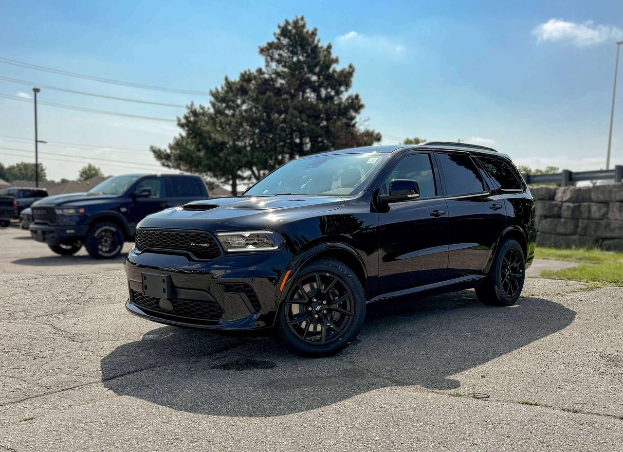 Built for action, the New 2026 Dodge Durango GT Premium AWD with the Blacktop Package in Diamond Black delivers sporty strength and confidence for spirited adventures. Powered by a 5.7 Litre HEMI V8 serving up 360hp to a paddle-shifted 8 Speed Automatic transmission for moving with muscular confidence. This All Wheel Drive SUV also had a rear load-leveling suspension for enhanced capability, and it sees approximately 10.7L/100km on the highway. Looking bold and assertive, our Durango shows off the Blacktop Packs GT-Gloss black badging, black roof rails, LED lighting, dual exhaust outlets, 20-inch Black Noise wheels, a power liftgate, and gloss-black heated power mirrors.  The Durango GT Premium cabin supports up to seven occupants with standard three-row seating and features upscale heated/ventilated front seats, heated a heated steering wheel, and a 10.1-inch touchscreen powered by Uconnect&reg; 5. Wireless Apple CarPlay&reg; and Android Auto&reg;, Bluetooth&reg;, WiFi compatibility, and a 19-speaker Harman Kardon audio system help keep everyone connected and entertained.  Dodge has your back with high-tech safety features, protecting you and your crew with blind-spot monitoring, a rearview camera, rear cross-path detection, rear parking sensors, hill start assist, trailer sway damping, tire pressure monitoring, stability/traction control, and more. Families love the fierce nature of our fantastic Durango GT Premium! Save this Page and Call for Availability. We Know You Will Enjoy Your Test Drive Towards Ownership!