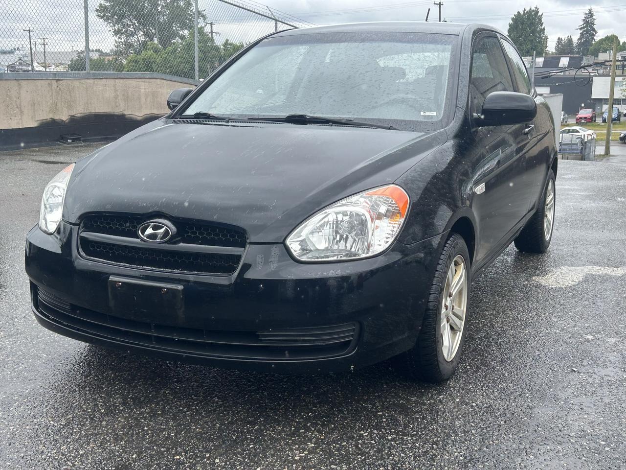 <p>Looking for a stylish and practical ride that wont break the bank? Milani Auto Sales is thrilled to present this sleek black 2010 Hyundai Accent 3dr HB Man L. This sharp coupe is perfect for navigating city streets or hitting the open road, offering a fun and engaging driving experience with its manual transmission. Its compact size makes it incredibly easy to park, while the sporty 3-door hatchback design ensures youve got surprising versatility for your everyday needs.</p><p>Under the hood, youll find a reliable 4-cylinder gasoline engine that delivers efficient performance, making it a smart choice for budget-conscious drivers. With its front-wheel-drive system, you can count on confident handling in various Canadian driving conditions. This Accent has been well-loved and shows 188,855 km, a testament to its enduring quality. Its ready for its next adventure with a new owner.</p><p>Here are five features that make this 2010 Hyundai Accent a truly exciting prospect:</p><ul><li><strong>Engaging Manual Transmission:</strong> Experience the thrill of being truly connected to the road with this responsive manual gearbox.</li><li><strong>Sporty 3-Door Coupe Design:</strong> Turn heads with its stylish and athletic profile, blending form and function.</li><li><strong>Fuel-Efficient 4-Cylinder Engine:</strong> Enjoy economical driving without sacrificing responsiveness for your daily commute.</li><li><strong>Nimble Front-Wheel Drive:</strong> Benefit from confident handling and agility, perfect for urban maneuverability.</li><li><strong>Compact & Versatile Hatchback Body Style:</strong> Effortlessly blend practicality with sporty aesthetics for all your cargo and passenger needs.</li></ul><p><strong><em>Powered by AutoIntelligence&trade;</em></strong></p><p>Vehicle information has been generated using artificial intelligence and is provided for informational purposes only. While efforts are made to ensure accuracy, please confirm all details directly with the dealer.</p>