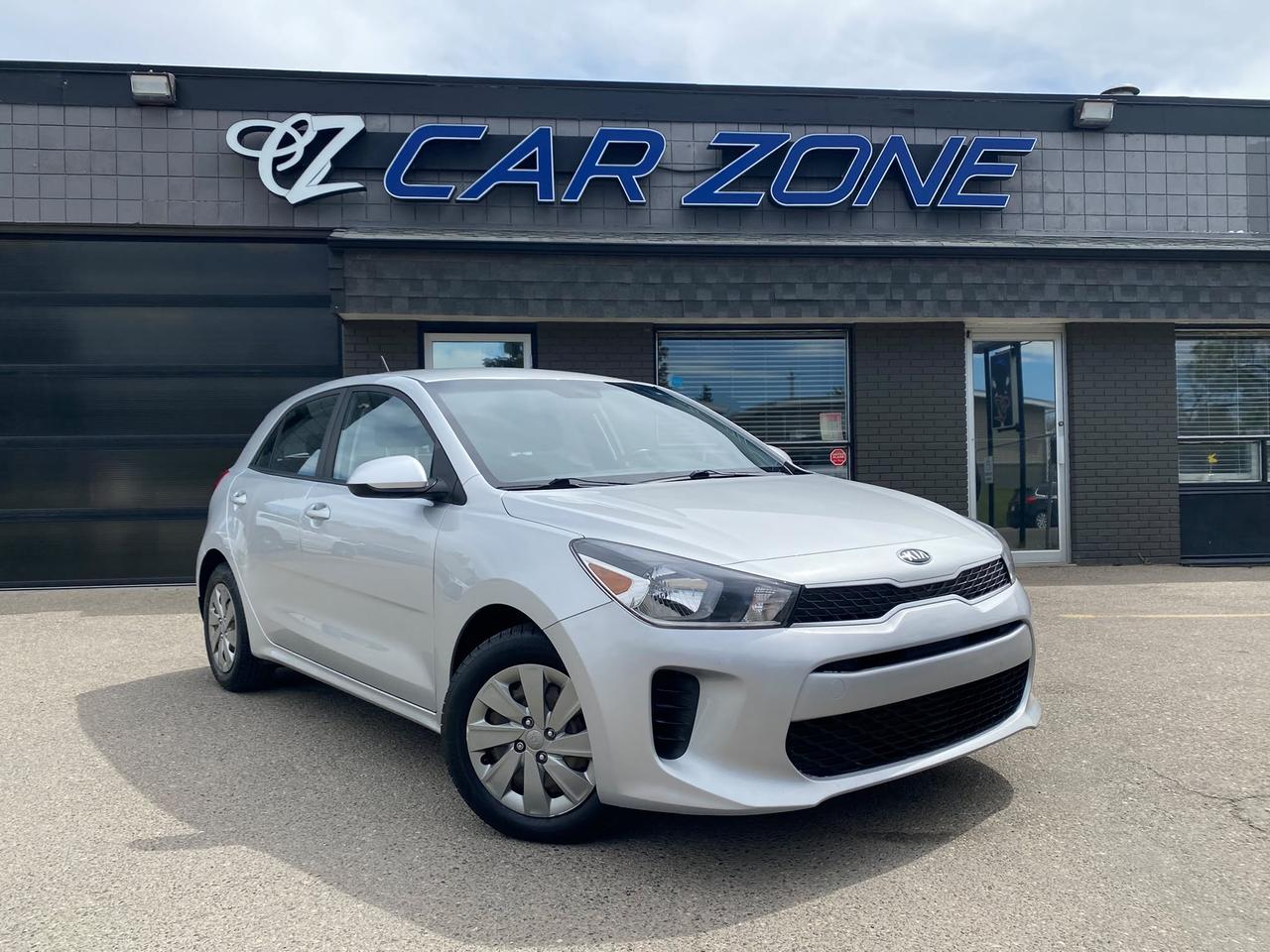 <p>Looking for a reliable and stylish ride that wont break the bank? Car Zone has an excellent option for you: a pre-owned 2020 Kia Rio LX+ hatchback in a sleek silver exterior with a unique black and blue interior. This car is perfect for navigating city streets or heading out on a weekend adventure, offering a fantastic blend of practicality and modern design. With its 1.6L 4-cylinder engine and smooth automatic transmission, youll enjoy an efficient and responsive driving experience, all while benefiting from the added security of front-wheel drive.</p><p>This 2020 Kia Rio LX+ has been driven approximately 91,000 km and is ready for its next chapter with a new owner. Whether youre a first-time car buyer, looking for a dependable commuter, or simply seeking a smart and fuel-efficient vehicle, this Rio LX+ is sure to impress. Its four-door hatchback configuration provides ample cargo space for groceries, gear, or whatever your lifestyle demands. Come on down to Car Zone and see for yourself why the Kia Rio is a popular choice for drivers across Canada!</p><p>Here are 5 standout features that make this 2020 Kia Rio LX+ a truly exciting find:</p><ul><li><strong>Stylish Black+Blue Interior:</strong> Elevate your driving experience with an interior that pops, featuring a distinctive black and blue colour combination that sets this Rio apart from the ordinary.</li><li><strong>Fuel-Efficient 1.6L Engine:</strong> Zip through your daily commute and weekend drives with confidence, knowing youre powered by a capable and economical 1.6L 4-cylinder engine that prioritizes savings at the pump.</li><li><strong>Versatile Hatchback Design:</strong> Maximize your utility with the practical and flexible hatchback body style, offering surprisingly generous cargo space for all your adventures and everyday needs.</li><li><strong>Smooth Automatic Transmission:</strong> Enjoy effortless driving and seamless gear changes with the responsive automatic transmission, making every journey a comfortable and stress-free experience.</li><li><strong>Front-Wheel Drive Reliability:</strong> Navigate diverse Canadian road conditions with the dependable grip and stability of front-wheel drive, providing peace of mind no matter the weather.</li></ul><p><strong><em>Powered by AutoIntelligence&trade;</em></strong></p><p>Vehicle information has been generated using artificial intelligence and is provided for informational purposes only. While efforts are made to ensure accuracy, please confirm all details directly with the dealer.</p>