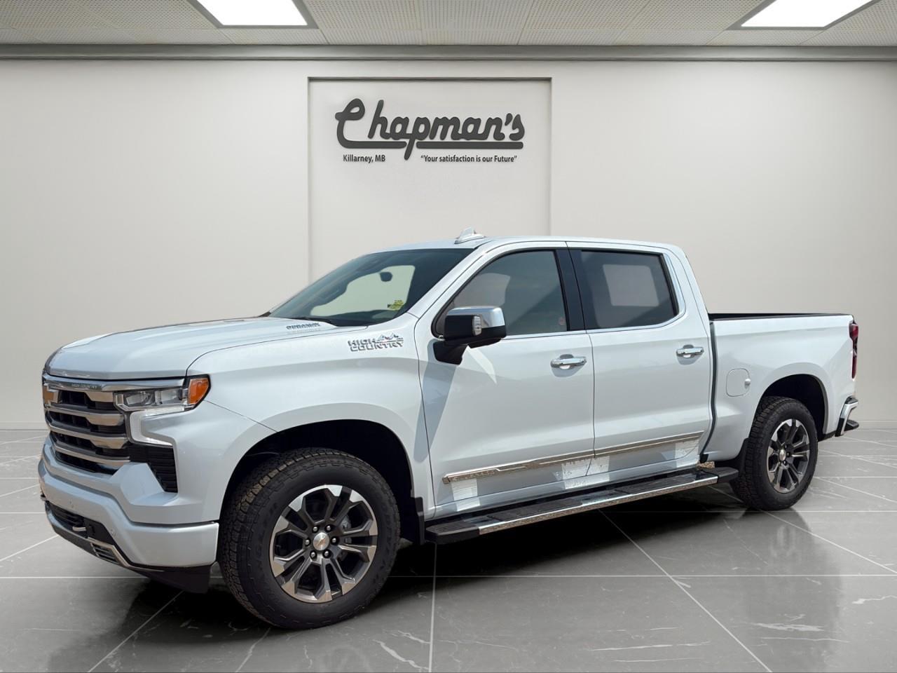 <p>Finished in stunning Polar White Tricoat with a premium Jet Black and Umber leather interior, this 2026 Chevrolet Silverado 1500 High Country delivers the perfect combination of luxury, capability, and efficiency. Powered by the impressive Duramax 3.0L Turbo-Diesel engine and equipped with the High Country trim, Technology Package, and Z71 Off-Road Package, this Silverado is ready to tackle everything from long highway trips to demanding job sites.</p><p>Under the hood is the highly acclaimed Duramax 3.0L Turbo-Diesel paired with a refined 10-speed automatic transmission, providing exceptional torque, impressive towing capability, and outstanding fuel economy. Combined with the Z71 Off-Road Package, Autotrac 2-speed transfer case, and trailering equipment, this Silverado is built to perform wherever the road takes you.</p><h3>Performance & Capability</h3><p> Duramax 3.0L Turbo-Diesel engine  10-speed automatic transmission  Four-wheel drive (4WD)  Z71 Off-Road Package  Off-road suspension  Autotrac 2-speed transfer case  Automatic locking rear differential  Skid plates  Hill Descent Control  Heavy-duty air filter  Trailering Package with Hitch Guidance  Integrated trailer brake controller  StabiliTrak with Trailer Sway Control and Hill Start Assist  All-terrain tires</p><h3>Interior Comfort & Convenience</h3><p> Heated and ventilated front bucket seats  Heated rear outboard seats  Driver seat and mirror memory  Adaptive Cruise Control  Heated leather-wrapped steering wheel  Wireless phone charging  Remote vehicle start  Keyless Open, Lock and Start  Universal Home Remote  Power rear sliding window  Power sunroof  120V power outlets in the cab and cargo bed</p><h3>Technology & Connectivity</h3><p> Chevrolet Infotainment 3 Premium with 13.4" touchscreen  Google Built-In with navigation capability  Wireless Apple CarPlay & Android Auto  Bose premium audio system  15" multicolor Head-Up Display  Rear Camera Mirror  Bluetooth connectivity  SiriusXM with 3-year subscription  OnStar Basics connected services  Driver Information Centre</p><h3>Safety & Driver Assistance</h3><p> HD Surround Vision  Enhanced Automatic Emergency Braking  Forward Collision Alert  Front Pedestrian Braking  Lane Keep Assist with Lane Departure Warning  Following Distance Indicator  Trailer Side Blind Zone Alert  Front and Rear Park Assist  IntelliBeam automatic high beams  Teen Driver technology</p><h3>Exterior Highlights</h3><p> Polar White Tricoat exterior  Chrome assist steps  Chrome recovery hooks  Chevytec spray-on bedliner  Power up/down tailgate  12 cargo tie-downs  LED cargo box lighting  LED reflector headlamps with signature DRLs  LED fog lamps and LED taillamps  Power-folding heated mirrors with driver-side auto-dimming  Dual exhaust outlets</p><p>The 2026 Silverado 1500 High Country combines premium refinement with diesel efficiency and proven Chevrolet capability, making it an exceptional choice for drivers who want luxury, advanced technology, and serious truck performance in one package.</p><p>2 Year/24,000 kilometer* Complimentary Oil Changes (2 total)</p><p>3 Year/60,000 kilometer* Base Warranty Coverage</p><p>5 Year/100,000 kilometer* Powertrain Component Warranty Coverage</p><p>5 Year/100,000 kilometer* Courtesy Transportation and 24/7 Roadside Assistance</p><p>6 Year/160,000 kilometer* Sheet Metal (Rust Through) Perforation Warranty Coverage</p><p>*Whichever Comes First.</p><p>Price Includes HD Flaps & 6 Tube Steps.</p><p>Price Includes Dealer Fee.</p><p>Price Excludes PST & GST.</p><p>Financing Options Available, Call For More Details.</p> <p><strong>*While every reasonable effort is made to ensure the accuracy of this information, we are not responsible for any error or omissions contained on these pages. Please verify any information in question with Chapman Motors Ltd.</strong></p>