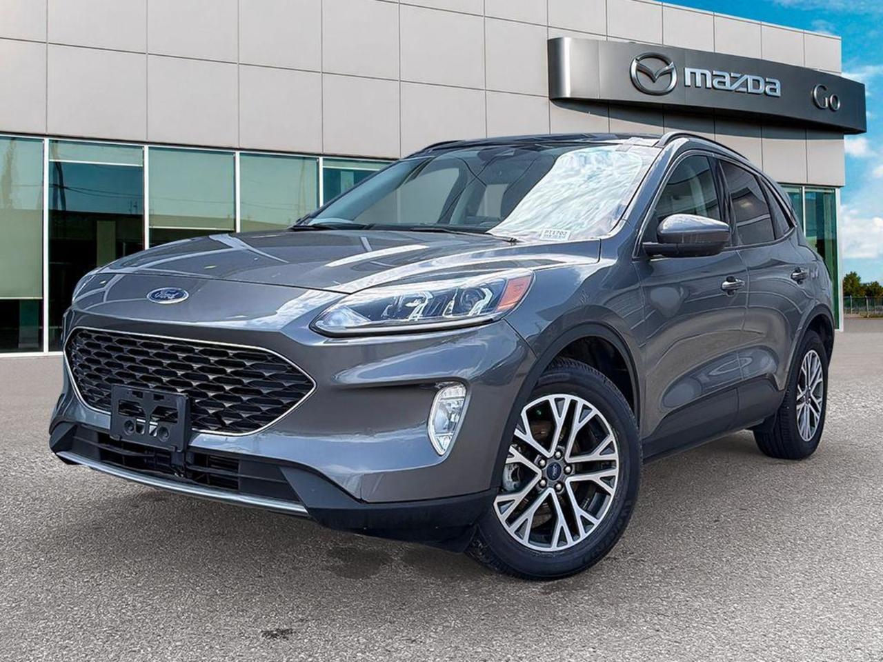 Discover the perfect blend of style, performance, and technology with this pre-owned 2022 Ford Escape SEL AWD in sophisticated Carbonized Gray exterior and sleek Black ActiveX interior. Powered by the efficient 1.5L EcoBoost engine paired with an 8-speed automatic transmission and full-time AWD, this Escape delivers confident handling in all conditions.Enjoy premium comfort with heated sport contour bucket seats, panoramic Vista roof, and dual-zone automatic climate control. Stay connected and safe with SYNC 3 touchscreen navigation, Ford Co-Pilot360 Assist+, adaptive cruise control with stop-and-go, evasive steering assist, blind spot warning, and lane departure prevention.Equipped with 18 machined-face aluminum wheels, black roof rails, and versatile cargo space with power liftgate, this Escape is ready for your daily drives and weekend adventures. Dont miss out on a well-equipped, stylish SUV that combines innovation and comfort effortlessly.Visit Go Mazda today for a test drive and experience the outstanding value and capability of this 2022 Ford Escape SEL AWD!