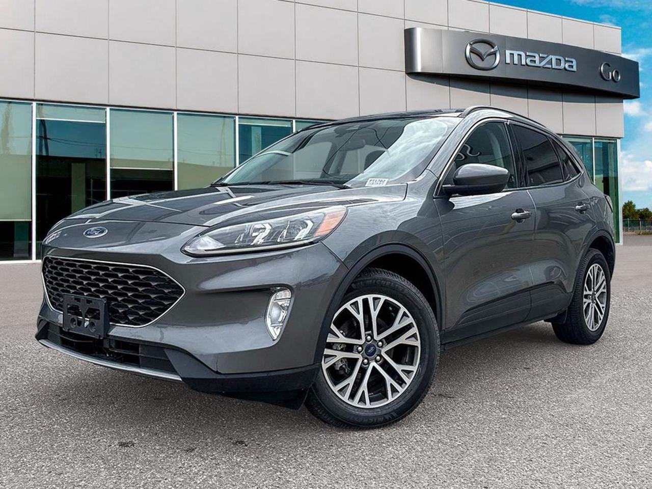 Discover the perfect blend of style, performance, and technology with this pre-owned 2022 Ford Escape SEL AWD in sophisticated Carbonized Gray exterior and sleek Black ActiveX interior. Powered by the efficient 1.5L EcoBoost engine paired with an 8-speed automatic transmission and full-time AWD, this Escape delivers confident handling in all conditions.Enjoy premium comfort with heated sport contour bucket seats, panoramic Vista roof, and dual-zone automatic climate control. Stay connected and safe with SYNC 3 touchscreen navigation, Ford Co-Pilot360 Assist+, adaptive cruise control with stop-and-go, evasive steering assist, blind spot warning, and lane departure prevention.Equipped with 18 machined-face aluminum wheels, black roof rails, and versatile cargo space with power liftgate, this Escape is ready for your daily drives and weekend adventures. Dont miss out on a well-equipped, stylish SUV that combines innovation and comfort effortlessly.Visit Go Mazda today for a test drive and experience the outstanding value and capability of this 2022 Ford Escape SEL AWD!