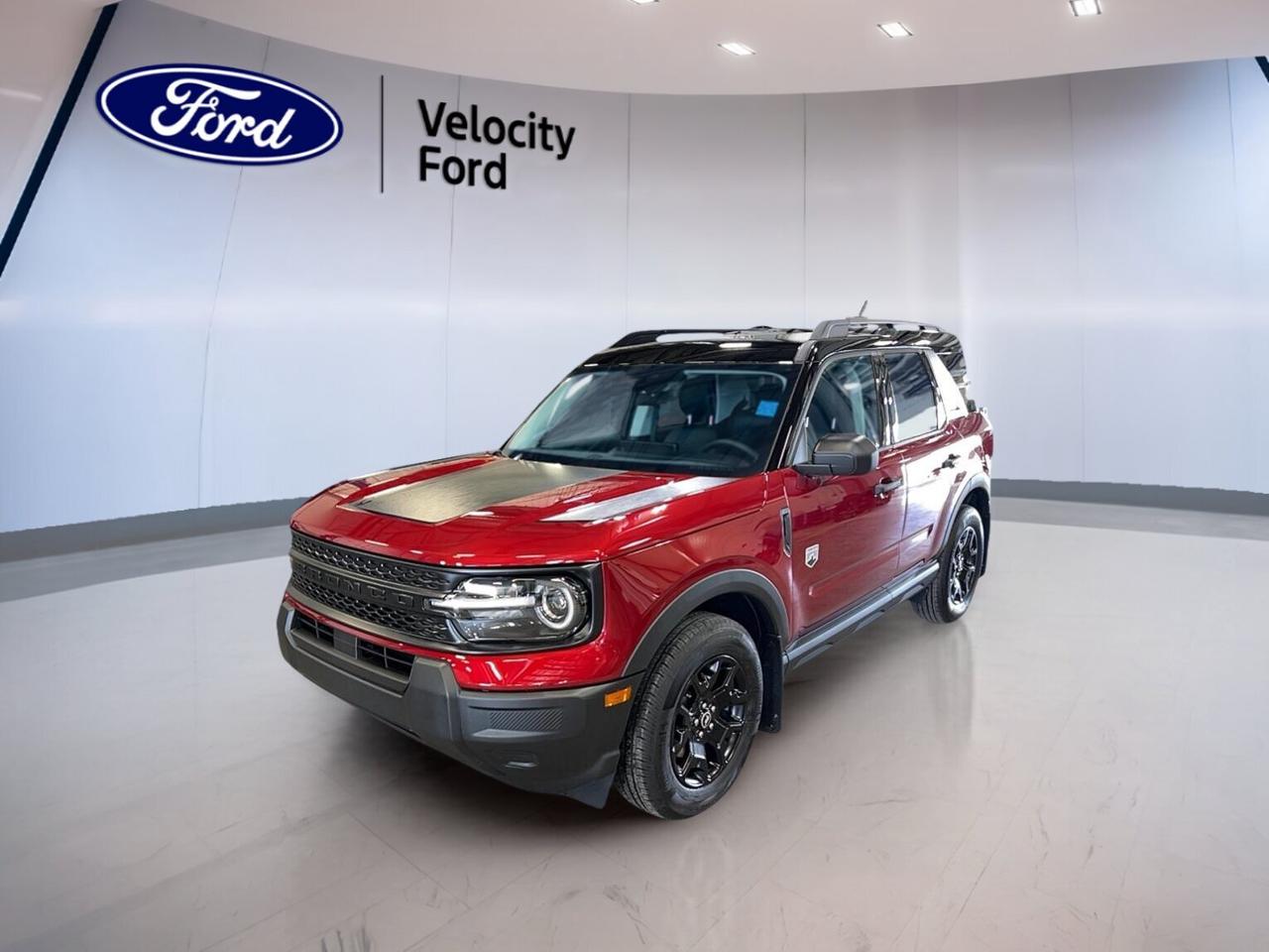 Built for Canadian roads and ready for daily life, the 2026 Ford Bronco Sport Big Bend 4x4 is a brand new SUV that blends rugged confidence with smart comfort. Finished in red with a black interior, this four-door model offers a practical size, standard four-wheel drive capability, and the versatility many Moose Jaw drivers want.

At Velocity Ford, this 2026 Ford Bronco Sport Big Bend 4x4 stands out with its 1.5-litre unleaded engine and smooth 8-speed automatic transmission. It is easy to drive in town, steady on the highway, and well suited to changing road and weather conditions. Its upright design also helps give a confident view ahead.

FEATURES OF THE Bronco Sport Big Bend 4x4
»» Standard four-wheel drive for added traction
»» 1.5-litre turbocharged gas engine performance
»» Eight-speed automatic transmission shifts smoothly
»» Four-door SUV with practical everyday versatility

ADVANCED SAFETY FEATURES
»» Backup camera helps with reversing visibility
»» Blind spot monitor aids lane awareness
»» Lane departure warning supports safer travel
»» Side and head airbags add protection

PERFORMANCE AND EFFICIENCY
»» 1.5-litre engine balances power and efficiency
»» Eight-speed automatic supports smooth acceleration
»» Four-wheel drive improves year-round confidence
»» Power steering helps easy low-speed handling

COMFORT AND CONVENIENCE
»» Heated front seats add cold-weather comfort
»» Automatic climate control keeps cabin pleasant
»» Cruise control supports relaxed highway driving
»» Power driver seat includes lumbar support

TECHNOLOGY AND CONNECTIVITY
»» Bluetooth integration supports hands-free calling
»» Wi-Fi hotspot helps keep devices connected
»» Satellite radio expands entertainment choices
»» Steering wheel audio controls feel convenient

CARGO SPACE
»» Rear trunk access makes loading simple
»» Four-door layout improves everyday usability
»» Flexible cargo area suits daily errands
»» Rear space handles gear and groceries

The 2026 Ford Bronco Sport Big Bend 4x4 also includes useful details that make each drive easier. Heated mirrors, power mirrors, power windows, automatic headlights, tinted windows, push button start, rear window defroster, and automatic door locks all help support a smooth ownership experience in every season.

Inside, the cabin is designed for comfort and function. Front air conditioning, illuminated driver and passenger vanity mirrors, and ambient lighting give the interior a clean and modern feel. The adjustable steering wheel helps drivers find a natural position, while the controls are simple and easy to reach.

This 2026 Ford Bronco Sport Big Bend 4x4 is also equipped with important core safety systems. Anti-lock braking system, stability control, tire pressure monitoring, child safety locks, passenger airbag sensor, driver airbag, and passenger airbag all work together to support peace of mind on the road.

WHAT OTHER OWNERS LIKE
»» Easy-to-drive size for everyday use
»» Comfortable ride with useful visibility
»» Confident four-wheel drive traction year-round
»» Practical cargo room for active lifestyles

This 2026 Ford Bronco Sport Big Bend 4x4s VIN is: 3FMCR9BN7TRE51796.