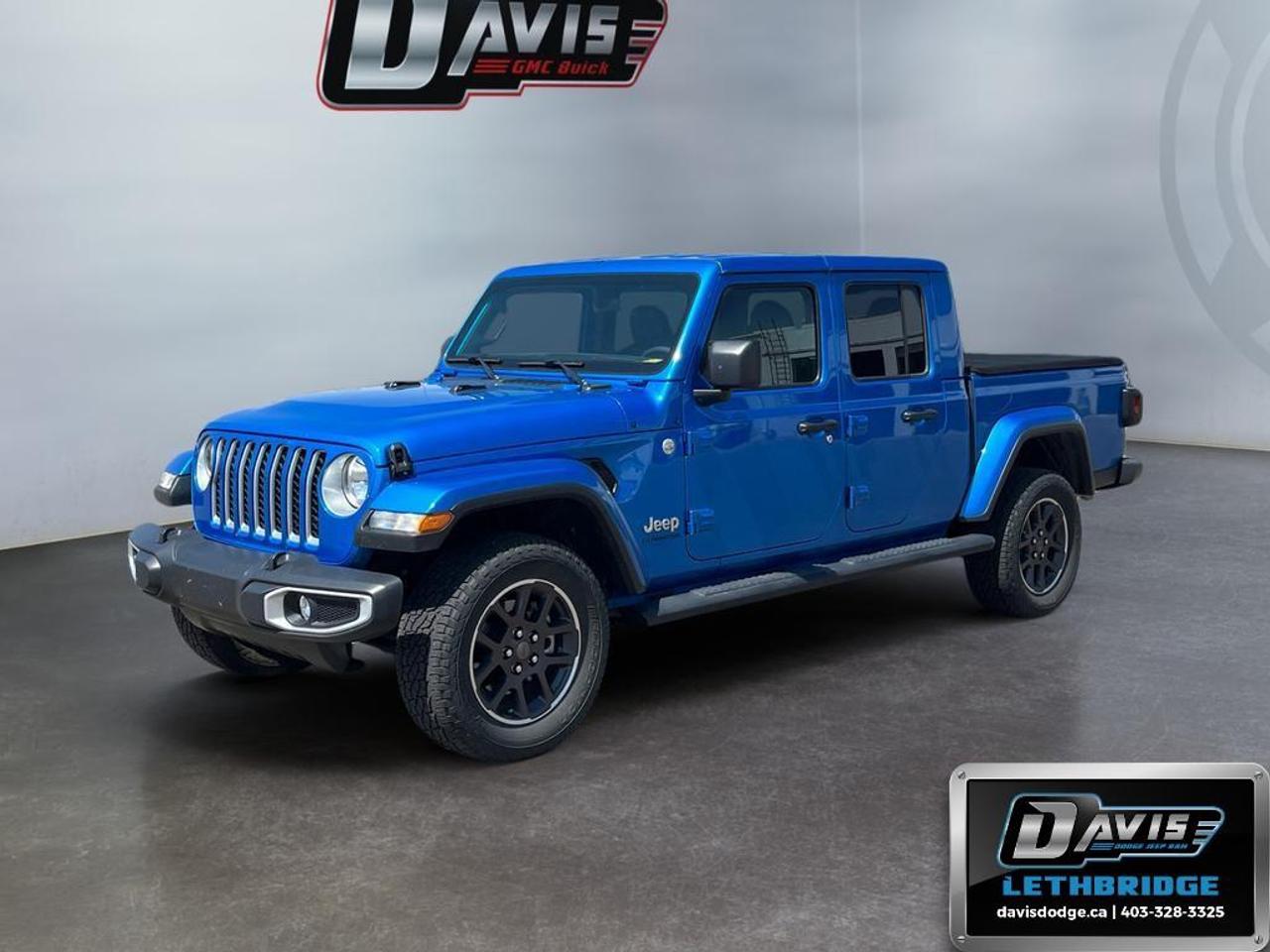 <b>Sunroof, Premium Audio, Navigation, Climate Control, Heavy Duty Suspension, Apple CarPlay, Android Auto, Tow Package, Proximity Key, 4G WiFi, Rear Camera<br /> <br /></b><br /> Take on every adventure in this 2023 Jeep Gladiator Overland 4x4 finished in Hydro Blue Pearl Coat with a body-colour hard top. Powered by the 3.6L Pentastar V6 and 8-speed automatic transmission, it delivers legendary Jeep capability with Command-Trac 4WD, trailer tow package, Class IV hitch, skid plates, and heavy-duty suspension.<br />Loaded with premium features including heated leather-trimmed seats, heated steering wheel, remote start, Alpine premium audio, navigation, Apple CarPlay, Android Auto, Bluetooth, and an 8.4-inch Uconnect touchscreen. Additional highlights include a backup camera, remote keyless entry, push-button start, 18-inch alloy wheels, and premium Overland styling.<br />This Gladiator Overland combines rugged off-road capability, advanced technology, and everyday comfort in one versatile Jeep truck.<br /><br /> <br />To apply right now for financing use this link: <a href=https://lethbridge.davisdodge.ca/free-credit-check/ target=_blank rel=nofollow noopener noreferrer>https://lethbridge.davisdodge.ca/free-credit-check/</a><br /> <br /><br />Locally Owned & Trusted for Over 35 Years  Davis Dodge in Lethbridge, AB <br /><br /> At Davis Dodge, weve proudly served the Lethbridge community for more than 35 years, offering an unparalleled car buying experience. Dont just take our word for itour Google reviews speak volumes about our commitment to exceptional service. <br /><br /> Delivery & At-Home Test Drives: Convenient options to suit your lifestyle. <br /><br /> Flexible Financing for Everyone: Get the vehicle you need with financing solutions tailored to your situation. <br /><br /> Full Mechanical Inspections & Professional Cleaning: Every vehicle is thoroughly inspected and cleaned before it hits our lot.<br /><br /> We take all makes and models on trade and offer competitive pricing with inventory that changes daily. Whether you're shopping for a Chrysler, Dodge, Jeep, RAM, or FIAT, our AMVIC Licensed dealership makes it easy to browse, buy, and drive away.<br /><br /> Located in Lethbridge, AB, we proudly serve customers in Fort Macleod, Taber, Claresholm, and Coaldale. Shop online or visit us today to experience the best in sales, service, and selection. Standard bank rates apply; taxes are additional.<br /><br /> Vehicle pricing offer shown expires 2026-07-31. <br /> Come by and check out our fleet of 50+ used cars and trucks and 110+ new cars and trucks for sale in Lethbridge. o~o