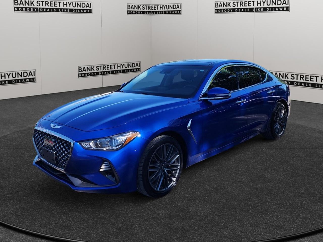 Introducing the stylish 2019 Genesis G70 2.0T Advanced in a striking blue finish. This all-wheel drive sedan is crafted for those who appreciate a dynamic driving experience, offering smooth handling paired with an automatic transmission. Step inside to discover a sophisticated interior equipped with luxurious touches like a leather steering wheel and leatherette door trim. The heated front seats and mirrors ensure comfort even on the chilliest of days, while the elegant chrome gear shifter adds a touch of class to your driving environment. Enjoy the open air with the included sunroof/moonroof, and the convenience of keyless entry and power seats. Tech enthusiasts will appreciate the smart device integration and Bluetooth connection for seamless connectivity. Safety is enhanced through features like a backup camera, lane assist, and adaptive cruise control, providing peace of mind on every journey. This Genesis G70 is perfect for anyone seeking a blend of luxury and performance in a sedan. Contact Bank Street Hyundai today to experience this remarkable vehicle for yourself and learn more about how it can be yours.