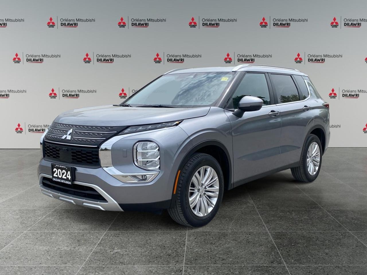 The 2024 Mitsubishi Outlander LE S-AWC in a sophisticated gray finish offers an impressive all-wheel drive system designed for remarkable handling and control, ensuring comfort across diverse driving conditions. This SUV showcases a striking exterior complemented by sleek alloy wheels that enhance its modern aesthetic. Slide into its spacious interior that features a host of premium options including comfortable heated seats and an expansive sunroof, perfect for taking in scenic panoramas on your journeys. With smart device integration and satellite radio, youll enjoy an immersive in-car entertainment experience. Equipped with cutting-edge technology, this Outlander boasts a user-friendly infotainment system and safety features, such as a backup camera, lane assist, parking sensors, and brake assist, all designed to keep you confidently in control. Keyless entry and Bluetooth connectivity add convenience to your everyday driving, while advanced driver assistance systems enhance safety on the road. This versatile SUV is tailored for families and adventurers alike, offering the practicality of a third row to accommodate all your passengers comfortably. Visit Orleans Mitsubishi to explore this exceptional vehicle further and make the 2024 Mitsubishi Outlander LE S-AWC yours.