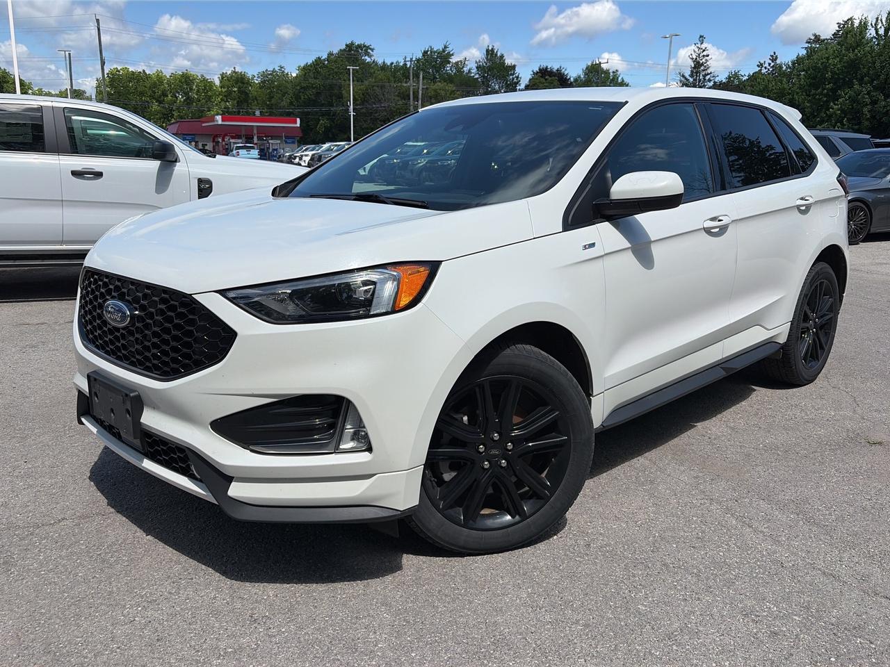 <p>Experience the perfect blend of sporty performance and everyday practicality with this stunning used 2022 Ford Edge ST Line AWD, now available at Winegard Ford. This eye-catching SUV boasts a sleek Star White Metallic Tri-Coat finish and a dynamic ST Line design, making it stand out from the crowd. With only 109,082 kilometers on the odometer, this Edge ST Line is ready for its next adventure, offering a comfortable and connected driving experience for you and your passengers.</p><p>&nbsp;</p><p>Step inside and discover a refined interior designed for both comfort and convenience. The ST Line trim elevates the cabin with premium ActiveX seating material and a host of advanced features. Whether youre navigating city streets or embarking on a road trip, this 2022 Ford Edge ST Line AWD provides a smooth, capable, and feature-rich ride, all backed by the reliability you expect from Ford.</p><p>&nbsp;</p><p>Here are 5 of the most sizzling features of this 2022 Ford Edge ST Line AWD:</p><p><br><br></p><ul><li><strong>Ford Co-Pilot360&trade; Assist+:</strong> This suite of advanced driver-assist technologies, including Adaptive Cruise Control with Stop & Go and Lane Centering, Evasive Steering Assist, and Connected Built-In Navigation, provides an extra layer of confidence and convenience on every journey.</li></ul><p>&nbsp;</p><ul><li><strong>2.0L EcoBoost Engine with Auto Start-Stop Technology:</strong> Experience exhilarating performance and impressive fuel efficiency thanks to the powerful yet smart EcoBoost engine, designed to optimize power delivery while minimizing waste.</li></ul><p>&nbsp;</p><ul><li><strong>ST Line Exterior and Interior Styling:</strong> Turn heads with the ST Lines aggressive black grille, body-coloured accents, and premium 20-inch gloss black-painted aluminum wheels, complemented by an interior featuring ActiveX seating material and sporty accents.</li></ul><p>&nbsp;</p><ul><li><strong>Power Liftgate and Cargo Space Lights:</strong> Effortlessly access the spacious cargo area with the convenient power liftgate, and keep your belongings visible with integrated cargo space lighting, perfect for any situation.</li></ul><p>&nbsp;</p><ul><li><strong>Cold Weather Package:</strong> Conquer Canadian winters with ease, thanks to the heated steering wheel and front and rear floor liners, ensuring comfort and protection no matter the temperature.</li></ul><p><br><br></p><p><strong><em>Powered by AutoIntelligence&trade;</em></strong></p><p>&nbsp;</p><p>Vehicle information has been generated using artificial intelligence and is provided for informational purposes only. While efforts are made to ensure accuracy, please confirm all details directly with the dealer.</p><p>&nbsp;</p>