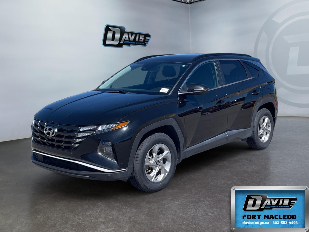 <p>Experience the 2022 Hyundai Tucson Preferred AWD in sophisticated black. With its all-wheel-drive handling, this SUV is ready to seamlessly navigate through any road condition.</p> <p><strong>Interior Features:</strong><br />  Spacious seating with Black Cloth Seat Trim<br />  Heated Front Seats and Heated Steering Wheel for ultimate comfort<br />  Leather Steering Wheel and Leather/Metal-Look Gear Shifter Material<br />  Power Windows and Keyless Entry for convenience</p> <p><strong>Exterior Features:</strong><br />  Bold Ash Black finish<br />  Alloy Wheels providing a stylish touch<br />  Heated Mirrors for better visibility<br />  Remote Start for those cold Canadian mornings</p> <p><strong>Technology & Safety Features:</strong><br />  Backup Camera to assist with parking<br />  Advanced Adaptive Cruise Control for easier highway driving<br />  Lane Assist to keep you on track<br />  Bluetooth Connection and Satellite Radio for quality entertainment<br />  Smart Device Integration for seamless connectivity<br />  Brake Assist enhancing braking performance</p> <p>This Hyundai Tucson is perfect for families or individuals seeking a reliable SUV equipped with modern comforts and technology. Contact Davis Dodge Fort Macleod today for more information and to arrange a test drive.</p>