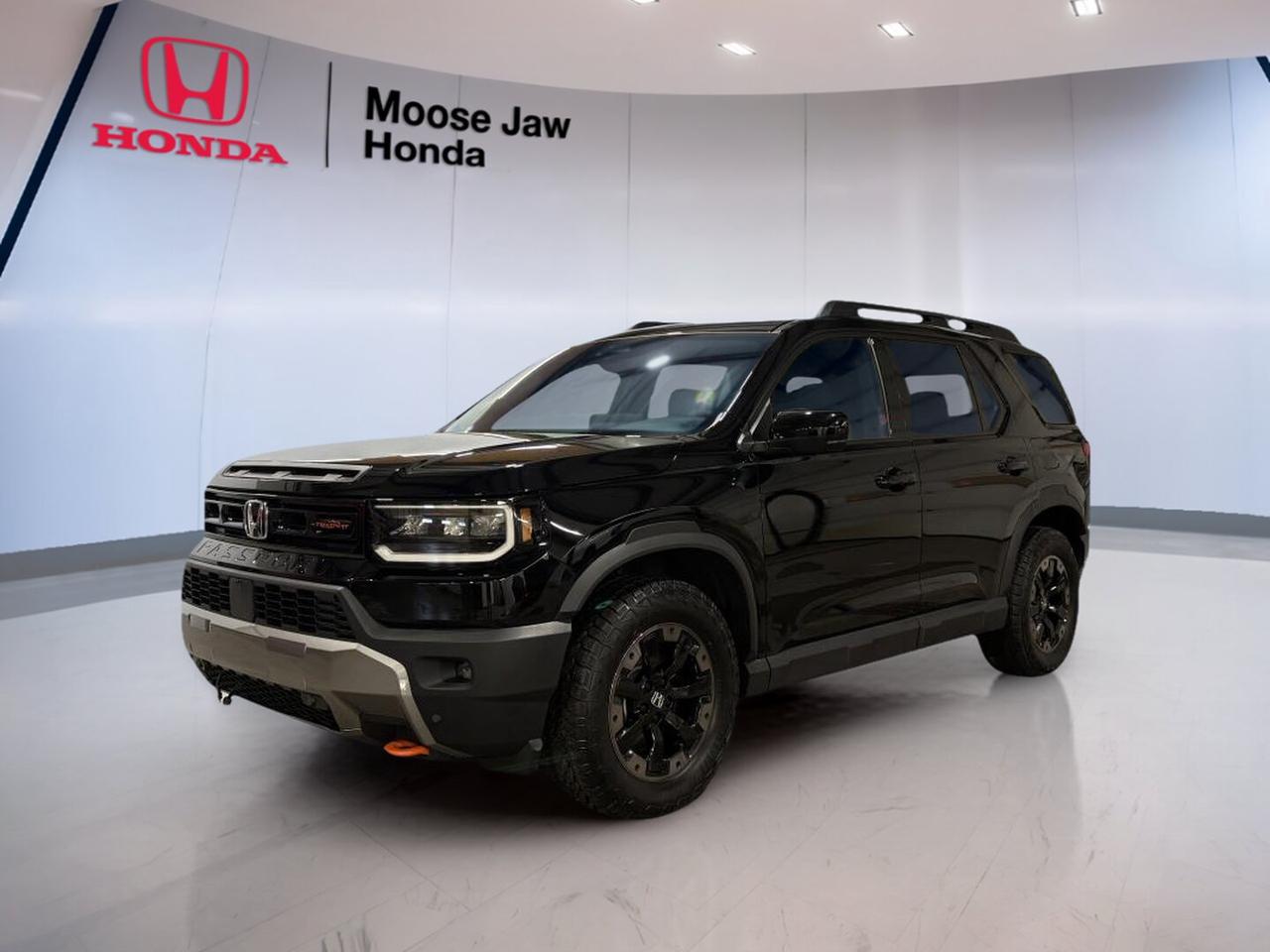 This used 2026 Honda Passport TrailSport Touring is ready for Saskatchewan roads with confident V6 power, all-wheel drive, and a bold black-on-black look. CARFAX Canada reports no accident, and the odometer shows 25,753 km. At Moose Jaw Honda in Moose Jaw, this SUV offers rugged capability with strong everyday comfort.

The 2026 Honda Passport TrailSport Touring is built for drivers who want space, strength, and year-round confidence. Its 3.5-litre V6 engine works with a 10-speed automatic transmission for smooth response and steady highway performance. With Honda engineering and practical utility, this SUV fits family travel, commuting, and weekend escapes with ease.

FEATURES OF THE Passport Trailsport Touring

»» TrailSport design adds rugged touring character
»» All-wheel drive supports four-season traction
»» 3.5-litre V6 delivers strong passing power
»» 10-speed automatic shifts smoothly and quickly

ADVANCED SAFETY FEATURES

»» CARFAX Canada reports no accident history
»» Honda Sensing supports daily driving confidence
»» Advanced airbag system helps protect occupants
»» Stability systems assist in slippery conditions

PERFORMANCE AND EFFICIENCY

»» 3.5-litre V6 offers smooth strong output
»» 10-speed automatic supports refined highway cruising
»» All-wheel drive improves traction on roads
»» Balanced power suits travel and towing

COMFORT AND CONVENIENCE

»» Spacious cabin supports family road trips
»» Black interior gives a clean look
»» Four-door SUV layout eases daily access
»» Flexible seating helps handle busy routines

TECHNOLOGY AND CONNECTIVITY

»» Clear driver displays support easy monitoring
»» Modern controls are simple to reach
»» Automatic transmission includes manual shift function
»» Useful cabin layout keeps functions organized

CARGO SPACE

»» Wide rear cargo area adds versatility
»» SUV design supports gear and luggage
»» Rear space suits shopping or travel
»» Cabin storage helps organize smaller items

WHAT OTHER OWNERS LIKE

»» Strong V6 power for easy passing
»» Confident all-wheel drive in winter
»» Spacious interior for passengers and gear
»» Comfortable ride for long highway trips

The 2026 Honda Passport TrailSport Touring stands out as a smart choice for drivers who need real utility without giving up comfort. The black exterior brings a clean, upscale presence, while the black interior keeps the cabin timeless and easy to enjoy. Its capable drivetrain gives this SUV the confidence to handle changing weather and rougher routes.

For drivers in Moose Jaw who want a well-kept, accident-free SUV with practical mileage and proven Honda durability, this used 2026 Honda Passport TrailSport Touring deserves a close look. It delivers the space, strength, and confidence many buyers want in a modern SUV, all backed by the trusted team at Moose Jaw Honda.

This 2026 Honda Passport Trailsport Tourings VIN is: 5FNYF9H85TB500788 .<p>This used 2026 Honda Passport TrailSport Touring is ready for Saskatchewan roads with confident V6 power</p>
<p> this SUV offers rugged capability with strong everyday comfort.

The 2026 Honda Passport TrailSport Touring is built for drivers who want space</p>
<p> and year-round confidence. Its 3.5-litre V6 engine works with a 10-speed automatic transmission for smooth response and steady highway performance. With Honda engineering and practical utility</p>
<p> and weekend escapes with ease.

FEATURES OF THE Passport Trailsport Touring

»» TrailSport design adds rugged touring character
»» All-wheel drive supports four-season traction
»» 3.5-litre V6 delivers strong passing power
»» 10-speed automatic shifts smoothly and quickly

ADVANCED SAFETY FEATURES

»» CARFAX Canada reports no accident history
»» Honda Sensing supports daily driving confidence
»» Advanced airbag system helps protect occupants
»» Stability systems assist in slippery conditions

PERFORMANCE AND EFFICIENCY

»» 3.5-litre V6 offers smooth strong output
»» 10-speed automatic supports refined highway cruising
»» All-wheel drive improves traction on roads
»» Balanced power suits travel and towing

COMFORT AND CONVENIENCE

»» Spacious cabin supports family road trips
»» Black interior gives a clean look
»» Four-door SUV layout eases daily access
»» Flexible seating helps handle busy routines

TECHNOLOGY AND CONNECTIVITY

»» Clear driver displays support easy monitoring
»» Modern controls are simple to reach
»» Automatic transmission includes manual shift function
»» Useful cabin layout keeps functions organized

CARGO SPACE

»» Wide rear cargo area adds versatility
»» SUV design supports gear and luggage
»» Rear space suits shopping or travel
»» Cabin storage helps organize smaller items

WHAT OTHER OWNERS LIKE

»» Strong V6 power for easy passing
»» Confident all-wheel drive in winter
»» Spacious interior for passengers and gear
»» Comfortable ride for long highway trips

The 2026 Honda Passport TrailSport Touring stands out as a smart choice for drivers who need real utility without giving up comfort. The black exterior brings a clean</p>
<p> while the black interior keeps the cabin timeless and easy to enjoy. Its capable drivetrain gives this SUV the confidence to handle changing weather and rougher routes.

For drivers in Moose Jaw who want a well-kept</p>
<p> all backed by the trusted team at Moose Jaw Honda.

This 2026 Honda Passport Trailsport Tourings VIN is: 5FNYF9H85TB500788 .</p>