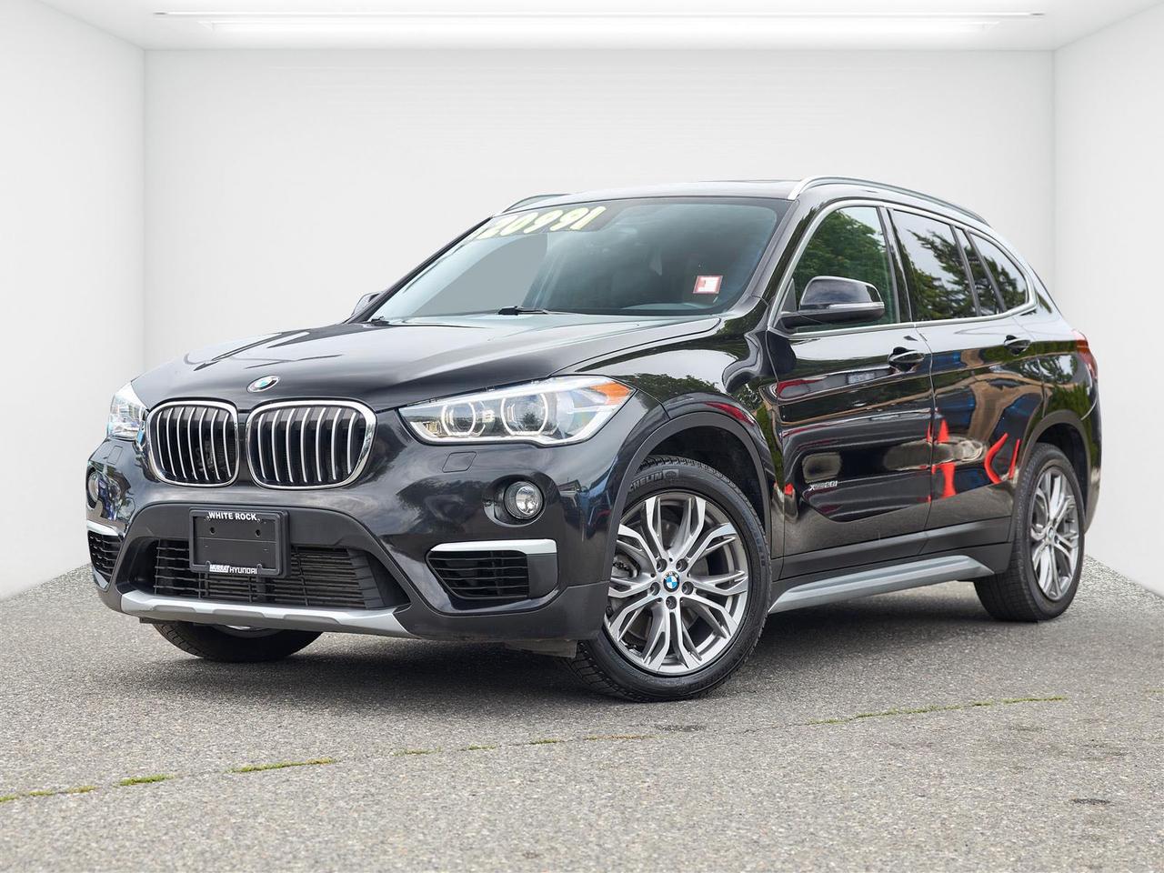 Premium Package | Panoramic Sunroof | AWD | Leather Interior | Heated Seats | Power Tailgate | Low KM | No Accidents<br><br>2017 BMW X1 xDrive28i AWD<br><br>The 2017 BMW X1 xDrive28i AWD in Jet Black is now available at White Rock Hyundai, offering premium luxury, sporty performance, and impressive practicality in a compact SUV. Powered by a turbocharged 2.0L TwinPower Turbo engine paired with an 8 speed automatic transmission and BMWs intelligent xDrive all wheel drive system, this X1 delivers a responsive and engaging driving experience while remaining comfortable for everyday use around White Rock, Surrey, Langley, and the Lower Mainland. With just 66,600 km, over 42,000 km below market average, and a clean no accident history, this is a rare low kilometre luxury SUV.<br><br>Equipped with the Premium Package, this X1 features a refined interior with premium materials, heated seats, and a panoramic sunroof that brightens the cabin. The spacious interior offers more cargo room and rear passenger space than many competitors, making it an excellent choice for both commuters and small families. A power tailgate, dual zone climate control, Bluetooth connectivity, and advanced BMW technology add convenience to every drive. If youre searching for a used BMW X1 for sale in White Rock, this low km xDrive28i combines luxury, practicality, and sporty performance in one attractive package.<br><br>Awards:<br>  * JD Power Automotive Performance, Execution and Layout (APEAL) Study   * 2017 IIHS Top Safety Pick<br><br>Reviews:<br>  * Strong performance from its turbocharged engine; one of the best-handling compact luxury crossovers youre going to find; class-leading cargo capacity; more rear passenger room than most other competitors; high-level interior fit, finish and materials; free maintenance for first four years or 50,000 miles. Source: Edmunds<br>  * Strong performance from its turbocharged engine; One of the best-handling compact luxury crossovers youre going to find; More rear passenger and cargo room than most other competitors; High-level interior fit, finish and materials Source: Edmunds<br><br>Why Buy From White Rock Hyundai?<br>* 7x Hyundai Presidents Award of Merit Winner<br>* 3x Consumer Choice Award for Business Excellence<br>* AutoTrader Dealer of the Year<br><br>M-Promise Certified Pre-Owned ($995 value) includes:<br>* 30-day / 2,000 km Exchange Program<br>* 3-day / 300 km Money Back Guarantee<br>* Comprehensive 144-Point Mechanical Inspection<br>* Full Synthetic Oil Change<br>* BC Verified CARFAX<br>* Minimum 6 Month Powertrain Warranty<br><br>Buy with confidence at White Rock Hyundai. Our vehicles are priced competitively based on market demand, condition, and kilometres to give our customers a transparent and hassle-free buying experience.<br><br>Visit White Rock Hyundai today to test drive this 2017 BMW X1 xDrive28i. We proudly serve drivers in White Rock, South Surrey, Surrey, Delta, Langley, and Vancouver with quality pre-owned vehicles and a professional, no-pressure experience.<br><br>Contact our team today to confirm availability, explore financing options, and reserve this vehicle.<br><br>* All vehicle purchases are subject to a $799 administration fee. Dealer #31129.
