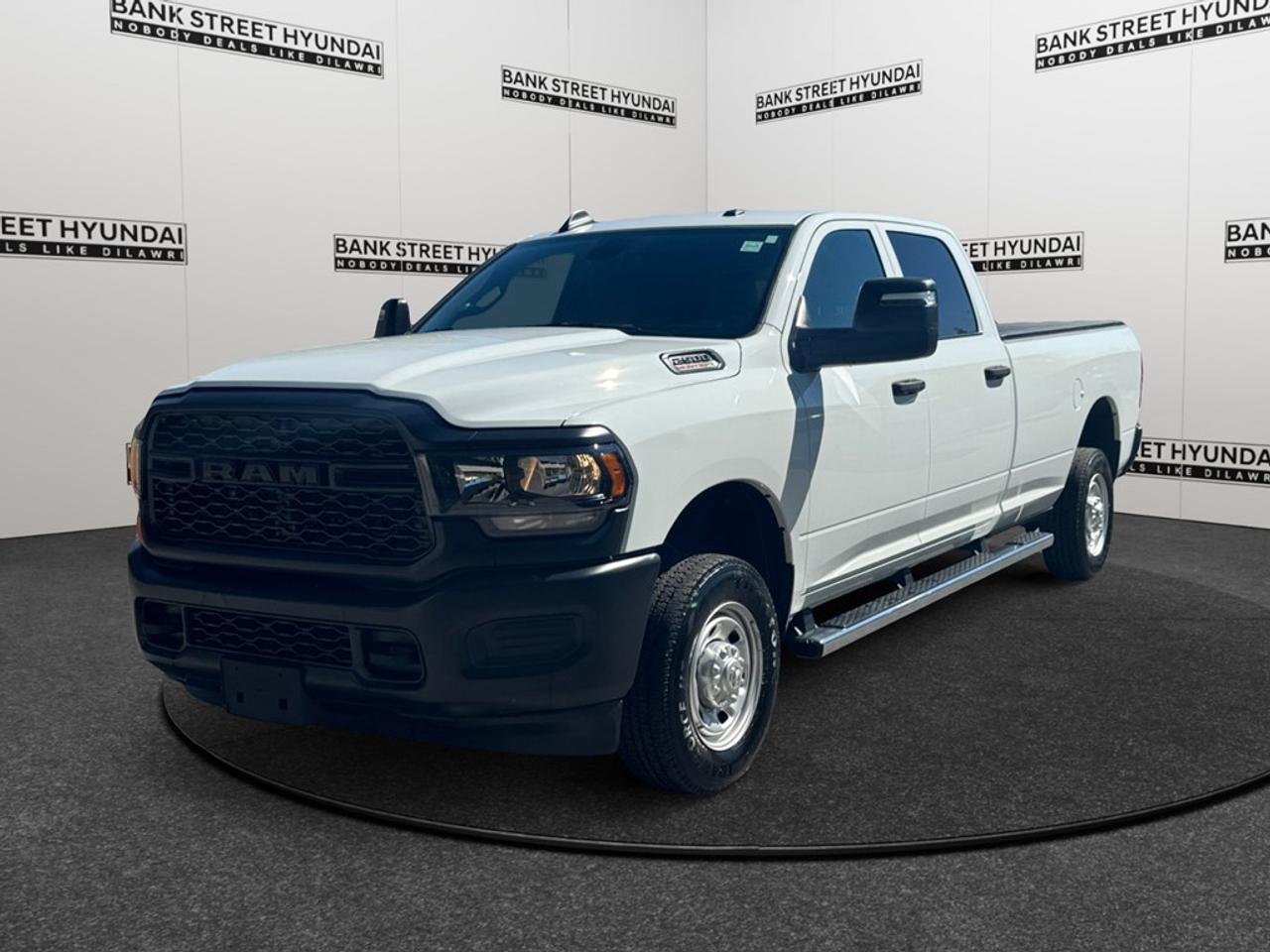 The 2024 Ram 2500 Tradesman in a rugged crew cab configuration with an imposing 4x4 drivetrain guarantees exceptional handling capabilities. Finished in a robust exterior that embodies strength and versatility, this trucks commanding presence turns heads while providing the utility you expect from a top-tier vehicle. Inside the Tradesman, find a world where practicality meets comfort. Equipped with power windows and keyless entry, the interior ensures convenience at your fingertips. The generous 8-foot box offers ample space for your hauling needs, keeping everything secure and organized with ease. Stay connected and in control with state-of-the-art technology that includes a backup camera and Bluetooth connection, enhancing your driving experience with seamless connectivity and increased safety. The cutting-edge cruise control and brake assist features add an extra layer of confidence, especially during long journeys or challenging terrains. Powered by the robust 6.4L HEMI V8 engine, this truck is perfectly tailored for those who require power combined with reliability. Ideal for individuals who value performance and functionality, the Ram 2500 Tradesman is an excellent choice for both work and recreational purposes. Contact Bank Street Hyundai today for more details on this outstanding vehicle and see how it can meet your demands.