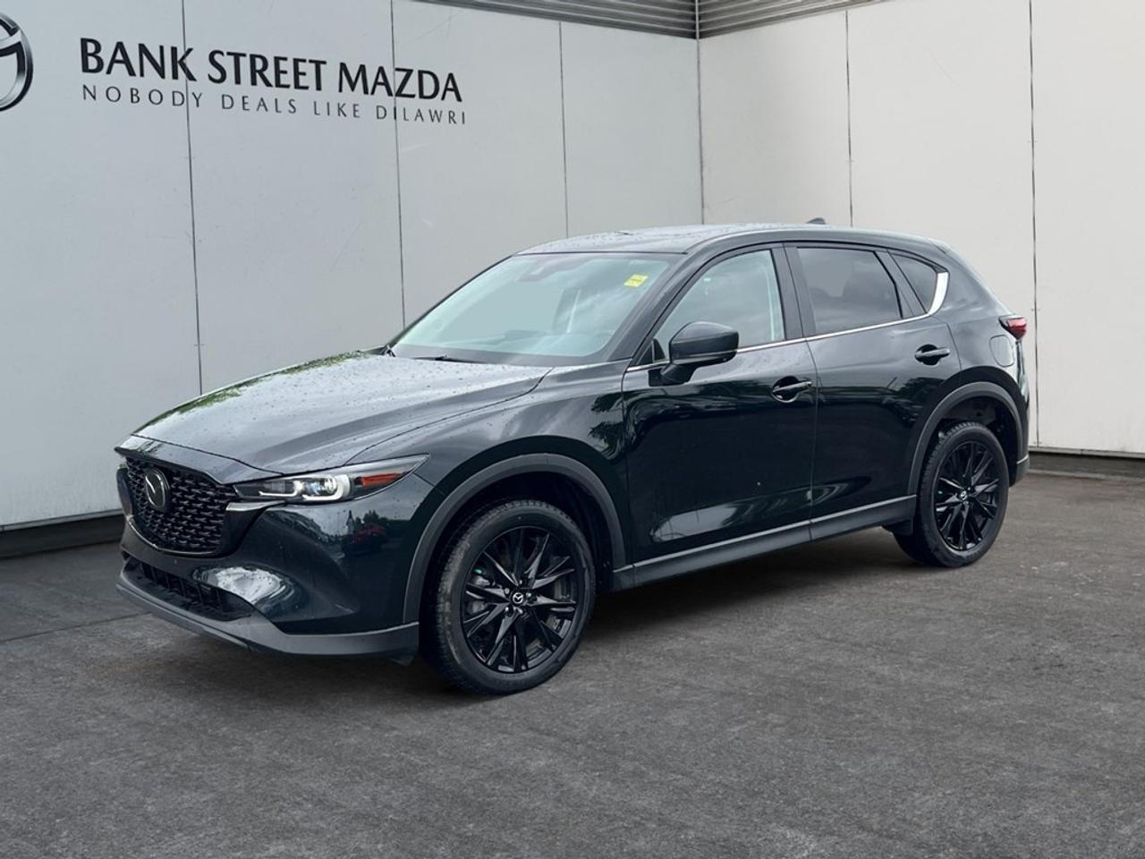 Experience the thrill of driving a 2022 Mazda CX-5 GS AWD, presented in a stunning black finish, complete with an automatic transmission and all-wheel drive that ensures exceptional handling no matter the terrain. The sleek SUV design boasts alloy wheels and a distinctive black exterior that is sure to impress. Inside, comfort meets functionality with features such as heated seats and power-adjustable seating, all accentuated by keyless entry for convenience. Stay connected and safe with the latest in smart device integration and Bluetooth connectivity, while driver assistance features including lane assist and a backup camera enhance your journey. Ensuring peace of mind, the Mazda CX-5 is equipped with brake assist and cruise control, allowing you to drive with confidence. This versatile SUV is perfect for families and adventurers alike. Get in touch with Bank Street Mazda to learn more about how the Mazda CX-5 can enhance your driving experience.
