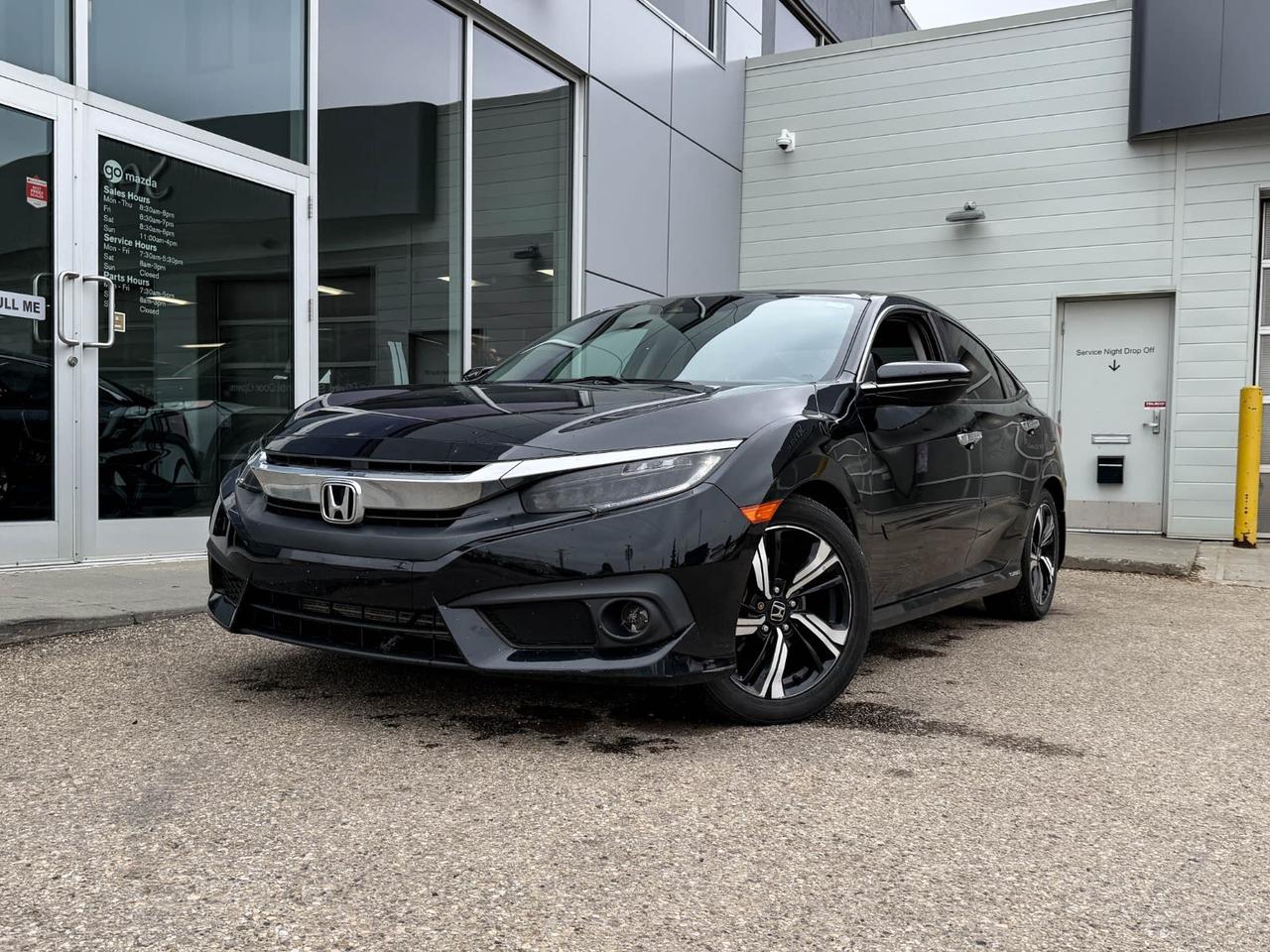Experience style, performance, and advanced tech with this pre-owned 2018 Honda Civic Sedan Touring in sleek Black. Powered by a turbocharged 1.5L I-4 engine paired with a smooth CVT, it delivers both efficiency and excitement. Enjoy premium comforts like heated leather-trimmed seats, dual-zone automatic climate control, and a moonroof for open-air driving. Stay connected with the integrated navigation system, 452-watt premium audio, and wireless device charging. Safety features include lane departure prevention, forward collision mitigation, and a rearview camera for peace of mind. This Civic Touring combines sporty design with top-tier technologyschedule your test drive today and elevate your driving experience!Go Mazda is an AMVIC licenced business
