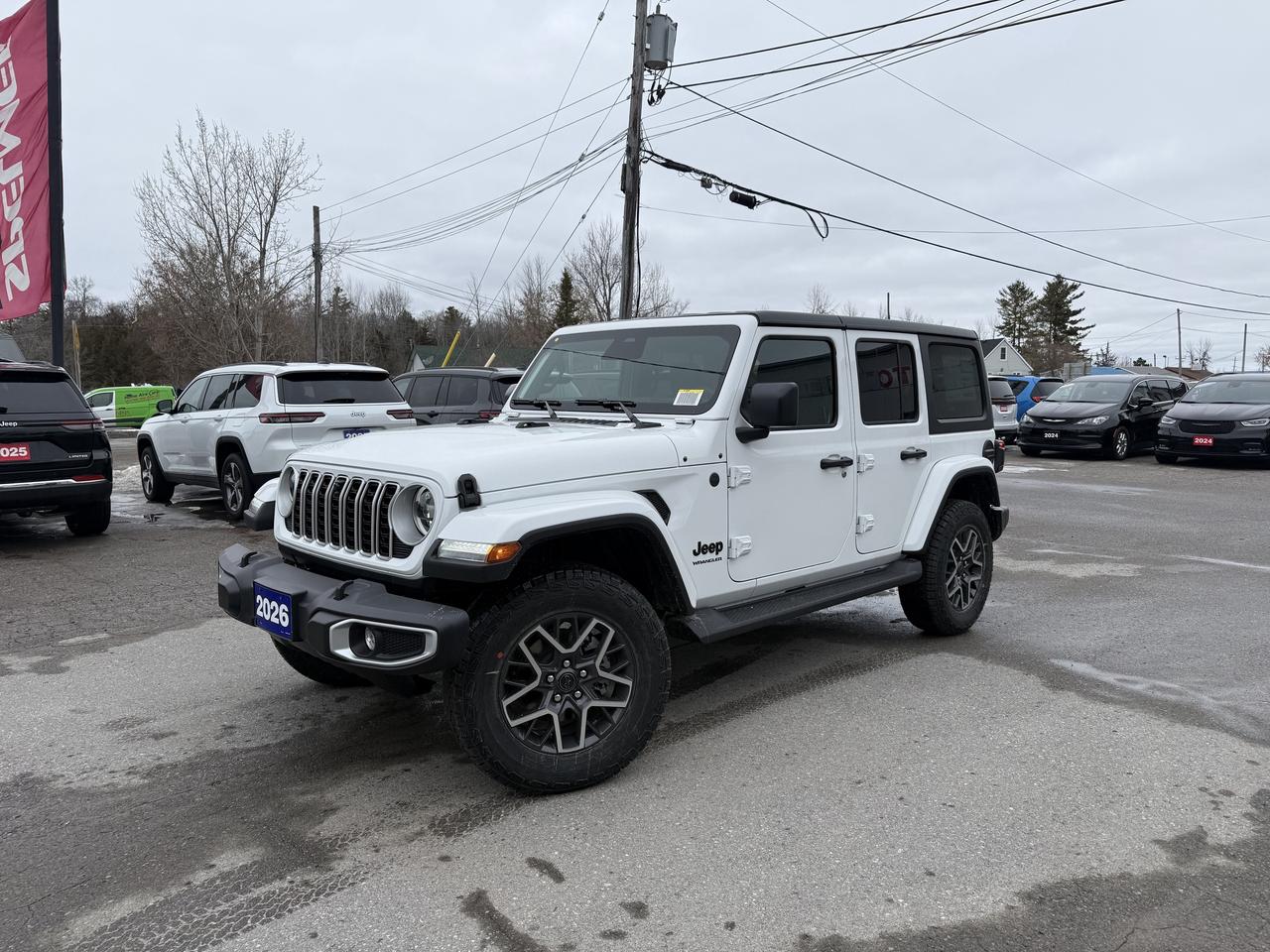 2026 JEEP WRANGLER SAHARA 4 DOOR 4X4.  3.6L PENTASTAR ENGINE WITH 8 SPEED AUTO TRANSMISSION.  12.3" SCREEN WITH NAVIGATION, MCKINLEY LEATHER HEATED SEATS, ALPINE SOUND SYSTEM, HEATED STEERING WHEEL, REMOTE START, POWER DRIVER & PASSENGER SEATS, TRAILER TOW & ELECTRICAL HD GROUP, REAR PARK ASSIST, BLIND SPOT MONITOR WITH REAR CROSS PATH DETECTION, ADAPTIVE CRUISE CONTROL, FORWARD COLLISION WARNING PLUS, INTEGRATED OFF-ROAD CAMERA, MOPAR ALL WEATHER FLOOR MATS, UNIVERSAL GARAGE DOOR OPENER, NON-VENTED STEEL HOOD, DANA M220 REAR AXLE, & MORE!  ONLY HST EXTRA.