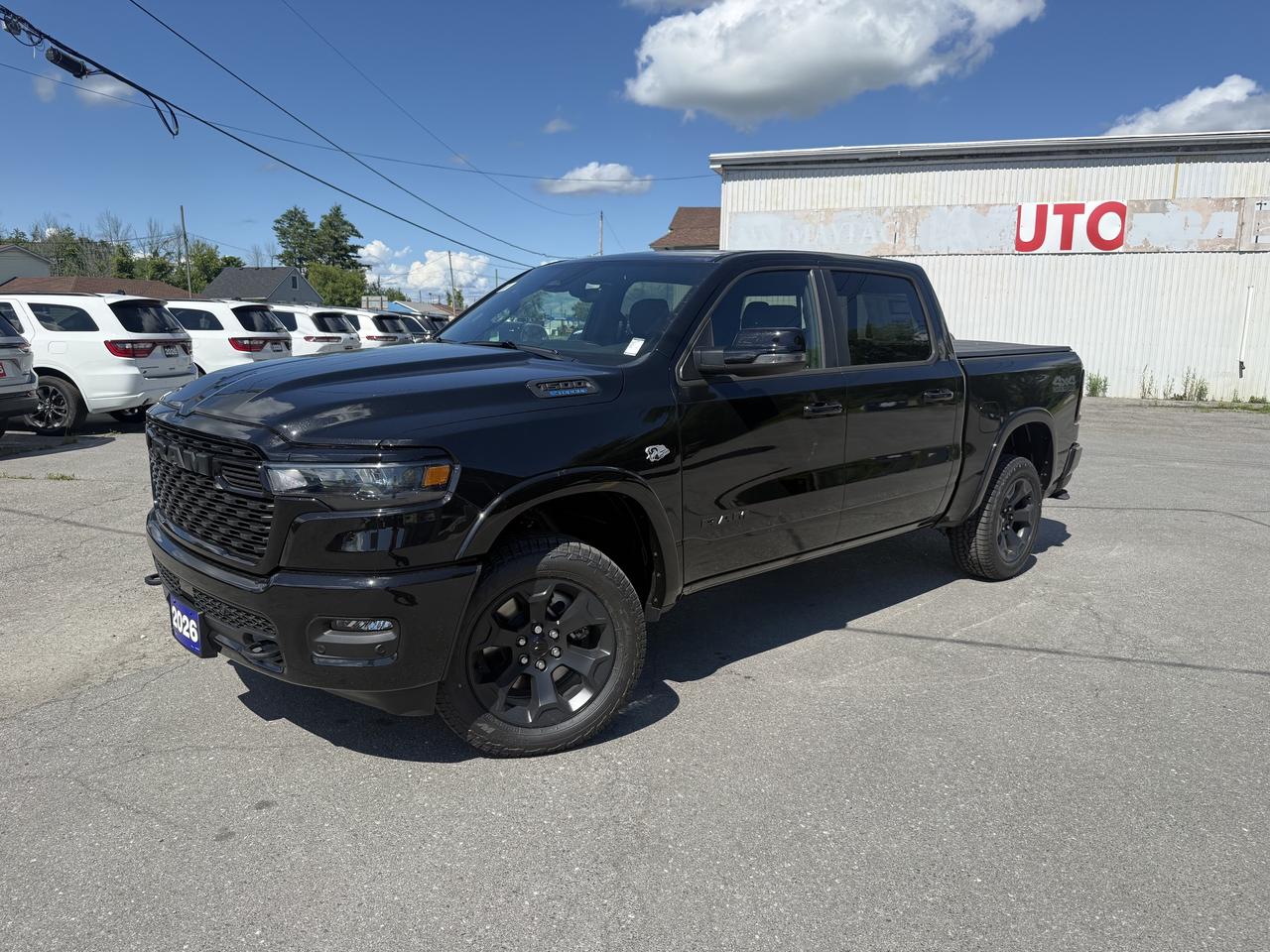 2026 RAM 1500 BIG HORN CREW CAB 4X4.  5.7L HEMI ENGINE WITH THE 3.92 REAR AXLE RATIO.  12" SCREEN WITH NAVIGATION, HEATED SEATS & STEERING WHEEL, REMOTE START,  RAISED RIDE HEIGHT, ALPINE SOUND SYSTEM, WIRELESS CHARGING PAD, TRI-FOLD TONNEAU COVER, POWER DRIVER SEAT, DUAL ZONE CLIMATE CONTROL, REAR POWER SLIDING WINDOW, REMOTE TAILGATE RELEASE, MOPAR ALL WEATHER FLOOR MATS, MOPAR SPRAY IN BEDLINER, DEPLOYABLE BED STEP, ADAPTIVE CRUISE CONTROL, BLIND SPOT MONITOR WITH REAR CROSS PATH DETECTION, FRONT & REAR PARK ASSIST, FORWARD COLLISION WARNING PLUS, ACTIVE LANE MANAGEMENT SYSTEM, DAMPENED TAILGATE, & MORE!  ONLY HST EXTRA.