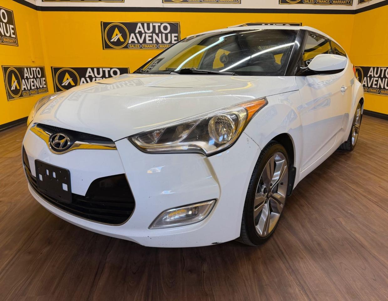 This outstanding example of a 2013 Hyundai Veloster is proudly offered by Auto Avenue Airdrie.<br /><br />Sporty, stylish, and packed with premium features, this Hyundai Veloster delivers a unique driving experience that perfectly blends performance, comfort, and modern design. With its bold exterior styling, smooth contours, and innovative technology, the Veloster stands out wherever it goes while offering the practicality needed for everyday driving.<br /><br />With only 126,066 km, it remains in excellent condition and continues to shine with a showroom-quality appearance. Whether youre navigating city streets or cruising on the highway, this hatchback offers responsive handling, impressive efficiency, and a fun-to-drive personality.<br /><br />Equipped with sought-after features including navigation, a panoramic sunroof, and heated seats, this Veloster is designed to keep you comfortable, connected, and entertained on every journey. The thoughtfully designed interior provides a modern cabin experience with convenient technology and versatile space for both passengers and cargo.<br /><br />The 2013 Hyundai Veloster is the ideal choice for drivers looking for sporty styling, advanced features, and exceptional value in a distinctive hatchback. This is more than just a vehicle - it&rsquo;s a perfect blend of practicality and personality built to elevate every drive.<br /><br />AUTO AVENUE IS AN AMVIC LICENSED DEALERSHIP, COMMITTED TO PROVIDING EXCEPTIONAL SERVICE AND QUALITY VEHICLES WITH FLEXIBLE PAYMENT OPTIONS. <br/>