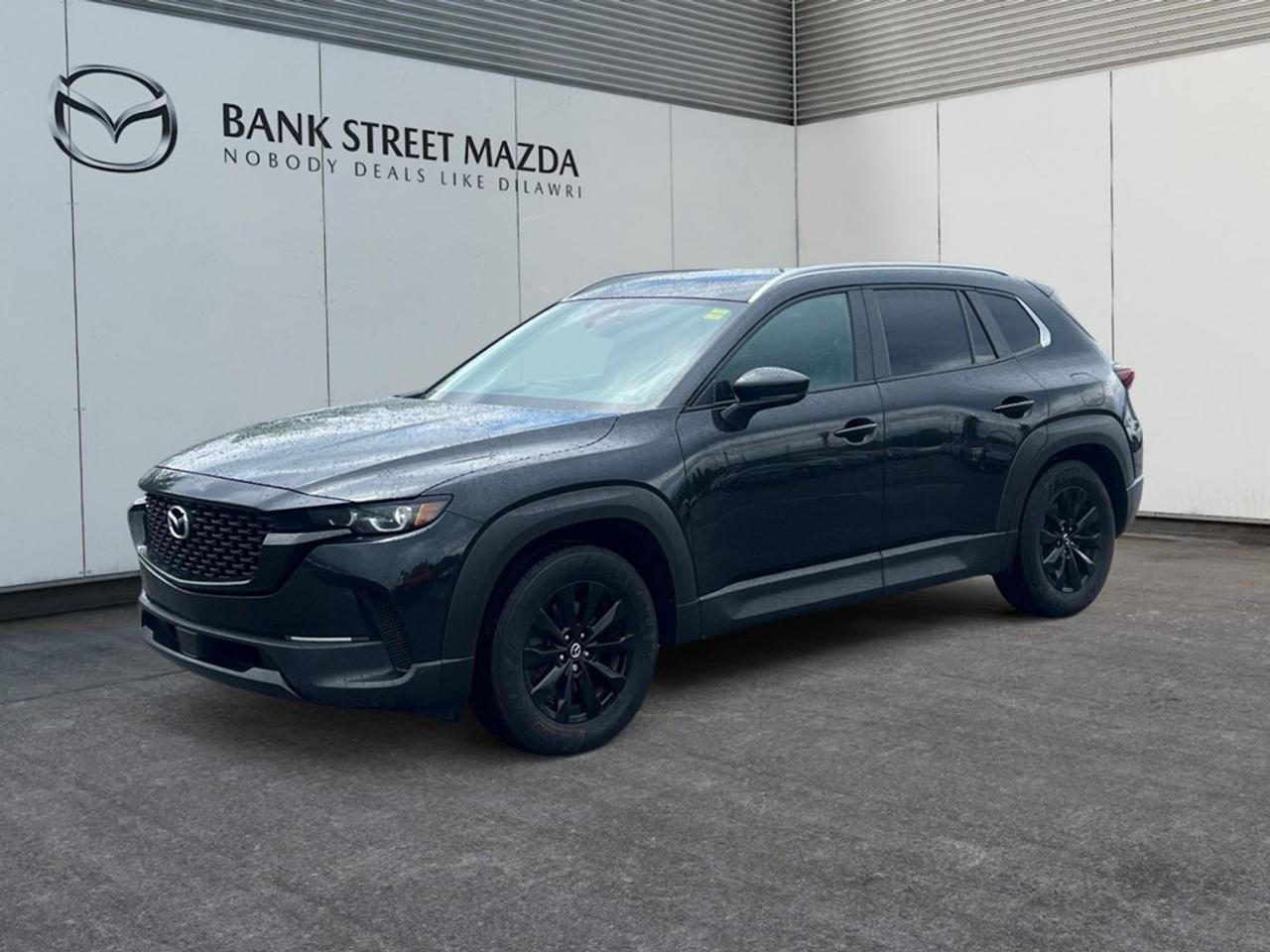Experience the thrill of the road with the 2024 Mazda CX-50 GS-L AWD. Dressed in a sleek black finish, this sporty SUV with its all-wheel-drive handling is perfect for navigating any terrain with confidence. The exterior boasts alloy wheels and a striking design, while the interior is loaded with comfort features such as heated seats, a leather steering wheel, and a sophisticated leatherette door trim insert. The combination of its sunroof/moonroof and power seats enhances your driving experience to another level. The CX-50 GS-L is equipped with the latest technology for your convenience and safety. Stay connected with smart device integration and enjoy the ease of keyless entry. Safety is paramount with features like a backup camera, brake assist, and lane assist, coupled with adaptive cruise control for relaxed long-distance travel. This vehicle is ideal for adventurous families or anyone who thrives on innovative technology and superior performance. Contact Bank Street Mazda today to find out more and schedule a test drive!