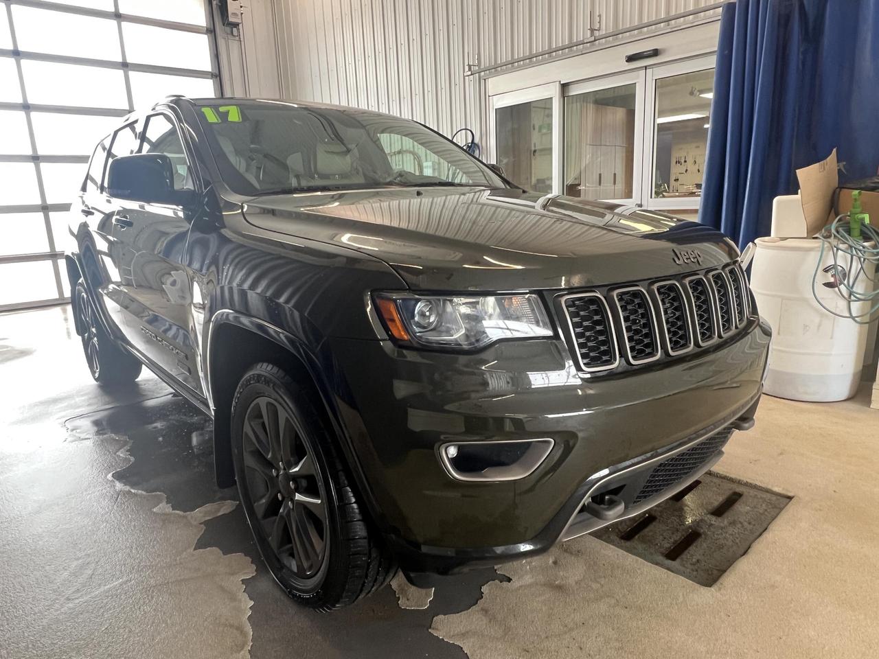 The 2017 Jeep Grand Cherokee Limited 75th Anniversary Edition brings a rare combination of rugged 4WD capability and refined interior comfort. Finished in striking Recon Green with a warm Beige leather interior, this is a purpose-built SUV for those who demand versatility without sacrificing everyday livability  at a price point that makes serious off-road heritage accessible.

- Rare 75th Anniversary Edition trim in exclusive Recon Green exterior finish
- Automatic Full-Time Four-Wheel Drive with 3.6L V6  ready for any terrain or weather condition
- Heated leather rear seat with 60/40 folding split-bench for flexible cargo and passenger use
- Heated leather/metal-look steering wheel with full steering wheel controls
- Blind-Spot and Rear Cross-Path Detection with auto-dimming passenger mirror for confident lane changes
- Dual Zone Front Automatic Air Conditioning with front infrared sensing for personalized comfort
- Power Liftgate for hands-free rear cargo access
- ParkView Back-Up Camera with a full suite of airbags and rear child safety locks

Interested in taking this Grand Cherokee for a spin? Contact Merit Ford Sales to book a test drive, ask any questions, or get started on your purchase today. Our team is here to make the process straightforward and stress-free.