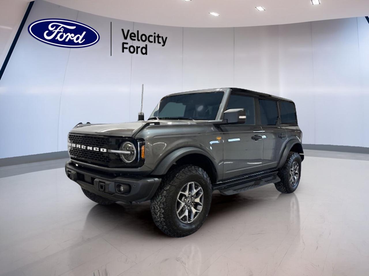 Meet the 2025 Ford Bronco Badlands 4 Door 4x4, a used SUV built for real adventure and everyday ease. Finished in Grey with a Black interior, this Bronco has only 11,117 km and brings rugged capability, open-air freedom, and modern comfort to Moose Jaw drivers who want more from every trip.

The 2025 Ford Bronco Badlands 4 Door 4x4 stands out with its trail-focused design, four-door practicality, and confident automatic transmission. Its 2.7-litre unleaded engine delivers strong power for highway travel, rough roads, and weekend escapes, while four-wheel drive helps keep you moving with control.

FEATURES OF THE Bronco Badlands 4 Door 4x4
»» 2.7-litre engine with strong low-end torque
»» Four-door layout adds daily practicality
»» Convertible design for open-air driving
»» Off-road tires support trail-ready capability

ADVANCED SAFETY FEATURES
»» Backup camera helps with reversing confidence
»» Blind spot monitor adds lane-change awareness
»» Lane departure warning supports safer travel
»» Side and head airbags add protection

PERFORMANCE AND EFFICIENCY
»» 2.7-litre unleaded engine delivers solid power
»» Four-wheel drive improves traction off-road
»» Limited slip differential boosts grip control
»» Automatic transmission supports smooth daily driving

COMFORT AND CONVENIENCE
»» Heated front seats add cold-weather comfort
»» Dual-zone climate control helps all passengers
»» Cruise control supports relaxed highway driving
»» Push button start adds everyday ease

TECHNOLOGY AND CONNECTIVITY
»» Navigation system helps guide every trip
»» Bluetooth integration supports hands-free connection
»» WiFi hotspot keeps devices connected
»» Steering wheel audio controls simplify access

CARGO SPACE
»» Rear trunk access makes loading easier
»» Four-door cabin improves passenger entry
»» Spare tire adds travel peace of mind
»» Flexible interior suits gear and groceries

WHAT OTHER OWNERS LIKE
»» Strong off-road ability in tough conditions
»» Easy removable-roof open-air driving experience
»» Comfortable ride with useful daily features
»» Modern tech paired with rugged design

This 2025 Ford Bronco Badlands 4 Door 4x4 also includes power steering, Anti-Lock Braking System, stability control, child safety locks, heated mirrors, electric mirrors, power windows, front air conditioning, tinted windows, satellite radio, leather steering wheel, automatic headlights, fog lights, tire pressure monitoring, automatic door locks, passenger airbag sensor, illuminated vanity mirrors, and LED headlamps.

With its low kilometres, capable 4x4 system, and smart mix of comfort and utility, the 2025 Ford Bronco Badlands 4 Door 4x4 is ready for workdays, road trips, and off-road weekends. Visit Velocity Ford in Moose Jaw to see how this Bronco fits your next adventure.

This 2025 Ford Bronco Badlands 4 Door 4x4s VIN is: 1FMEE9BP2SLB22555 .