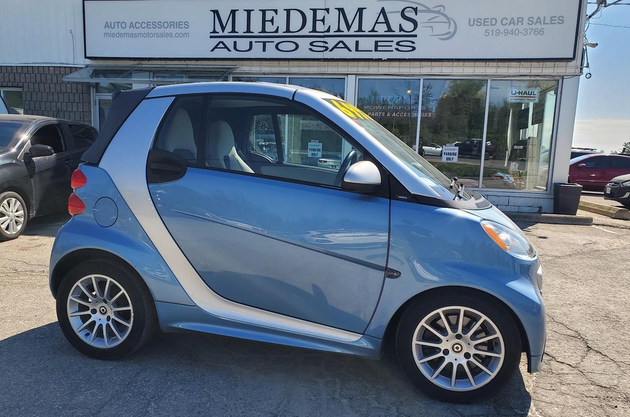<p>A fuel efficient convertible?! In this economy?!... YEP! This 2013 Smart has rear-wheel drive drivetrain, automatic transmission and impressive 1.0L 3 cylinder engine. 2 doors, 2 seats! Removeable top, ready for summer drives. Back-up sensors and rear glass window on the removable top. Heated seats and cold A/C! CERTIFIED and fresh oil change!</p><p>$6995 plus taxes and licensing</p><p>3 year/70 000km Lubrico warranty with up to $4000 per eligible claim and $150 deductible available for only an additional $1798+HST</p><p class=MsoNormal>Miedemas has been selling quality used cars since 1973! Honest, professional and friendly staff with that small town feel. No pressure buying! Come see what it takes to keep customers coming for over 40years in business! Financing available on qualified units! Warranty available! All cars sold certified with oil changed and ready to go unless otherwise posted. We&rsquo;re here to help.</p>