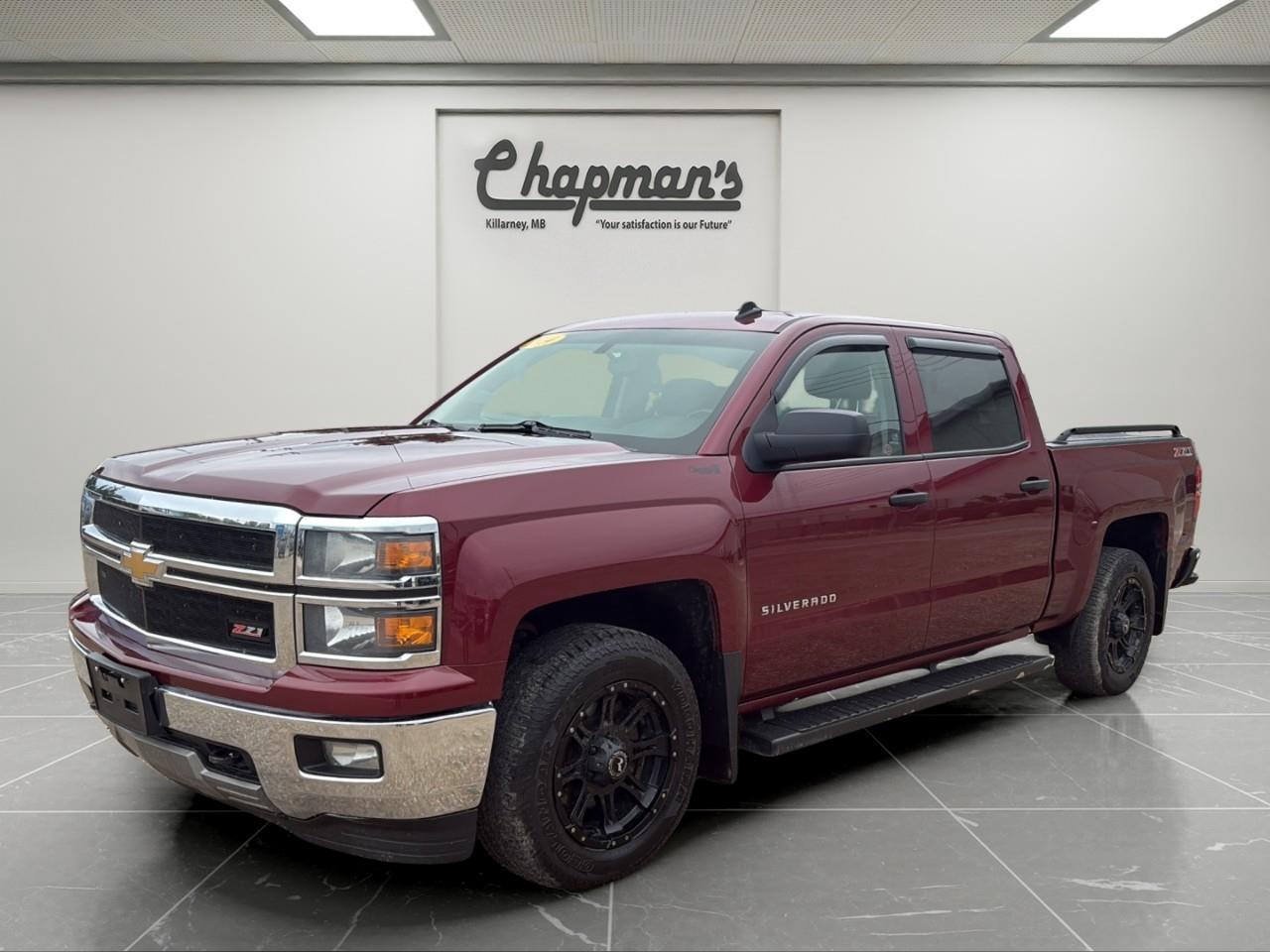 <p>Finished in Deep Ruby Metallic with a Jet Black interior, this 2014 Chevrolet Silverado 1500 LT Crew Cab combines proven V8 power, off-road capability, and everyday comfort in a versatile full-size pickup. Equipped with the True North Edition, Off-Road Suspension Package, and Trailering Package, this Silverado is built to tackle tough jobs while keeping drivers and passengers comfortable on every journey.</p><p>Powered by the EcoTec3 5.3L V8 engine paired with a 6-speed automatic transmission, this Silverado delivers impressive towing capability and dependable performance. With 4WD, an automatic locking rear differential, and the Autotrac 2-speed transfer case, it's ready for work, recreation, and challenging Canadian road conditions.</p><h3>Performance & Capability</h3><p> EcoTec3 5.3L V8 engine  6-speed automatic transmission  Four-wheel drive (4WD)  Autotrac 2-speed transfer case  Automatic locking rear differential  Off-Road Suspension Package  Trailering Package  Integrated trailer brake controller  Transmission fluid cooler  High-capacity air cleaner  Engine block heater  Front recovery hooks  Underbody transfer case shield</p><h3>Interior Comfort & Convenience</h3><p> Heated front bucket seats  Automatic climate control  Power sliding rear window  Remote vehicle start  Remote keyless entry  Power-adjustable pedals  Leather-wrapped steering wheel  Telescopic steering column  Universal Home Remote  Rear window defogger  110V AC power outlet  Power windows and door locks  Deep-tinted rear glass</p><h3>Technology & Connectivity</h3><p> Chevrolet MyLink with 8" colour touchscreen  SiriusXM Satellite Radio  OnStar with Turn-by-Turn Navigation  Bluetooth connectivity  Steering wheel audio controls  Single-slot CD player  Driver information centre  USB connectivity</p><h3>Safety & Driver Assistance</h3><p> Rear Vision Camera  Ultrasonic Rear Park Assist  StabiliTrak electronic stability control  Trailer Sway Control  Tire Pressure Monitoring System  Anti-lock braking system  Teen Driver-related safety technologies  Multiple airbags throughout the cabin</p><h3>Exterior Highlights</h3><p> Deep Ruby Metallic exterior  18" bright machined aluminum wheels  Chrome rear bumper with CornerSteps  Front fog lamps  LED cargo box lighting  Rear wheelhouse liners  Locking tailgate  Tire carrier lock  Wheel lock package  Heated power outside mirrors</p><p>This Silverado LT offers the perfect blend of V8 capability, off-road confidence, and premium comfort, making it an excellent choice for towing, hauling, and everyday driving.</p><p>Price Includes Dealer Fee.</p><p>Price Excludes PST & GST.</p><p></p> <p><strong>*While every reasonable effort is made to ensure the accuracy of this information, we are not responsible for any error or omissions contained on these pages. Please verify any information in question with Chapman Motors Ltd.</strong></p>