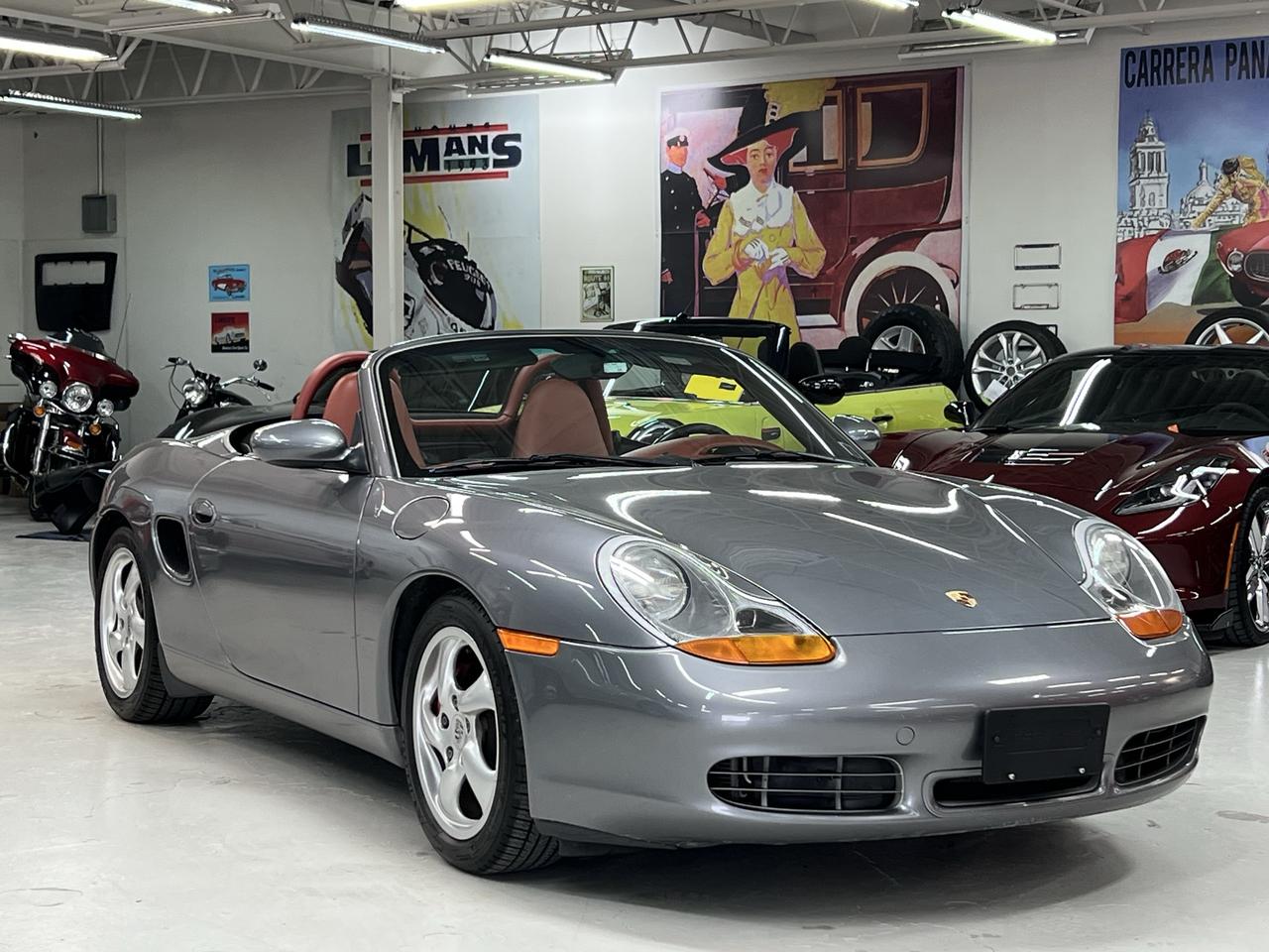 <p>135,069 kms | 6-Speed Manual | Boxster Red Special Leather | Collector Quality</p><p>There are sports cars, and then there are Porsches.</p><p>This 2002 Porsche Boxster S represents everything that made Porsches mid-engine roadster an instant classic: perfect balance, precise steering, timeless styling, and one of the most rewarding driving experiences available at any price.</p><p>Finished in elegant Seal Grey Metallic over the rare and stunning Boxster Red Special Leather interior, this is a beautifully specified example that stands apart from the ordinary black-on-black Boxsters that dominate the market.</p><p>Powered by Porsches legendary 3.2L flat-six producing 250 horsepower and paired with the desirable 6-speed manual transmission, the Boxster S delivers performance that still feels special today. The mid-engine layout provides exceptional balance and confidence, while the unmistakable sound of the naturally aspirated flat-six reminds you exactly why Porsche enthusiasts remain so passionate about these cars.</p><p>Factory equipped with:<br>&bull; 3.2L Flat-Six Engine<br>&bull; 6-Speed Manual Transmission<br>&bull; Boxster Red Special Leather Interior<br>&bull; Sport Package<br>&bull; Heated Seats<br>&bull; Porsche Stability Management (PSM)<br>&bull; 18 Sport Design Wheels<br>&bull; Power Convertible Top<br>&bull; Automatic Climate Control<br>&bull; Wind Deflector<br>&bull; Porsche Premium Audio<br>&bull; Cruise Control<br>&bull; Leather-Wrapped Sport Steering Wheel</p><p>The Boxster S has earned a reputation as one of the greatest drivers cars Porsche has ever built. Light, communicative, and beautifully balanced, it offers a level of steering feel and driver involvement that many modern sports cars have lost.</p><p>The condition of this example reflects careful ownership and proper maintenance. The paint, interior, trim, and overall presentation are exactly what enthusiasts hope to find in a Porsche of this calibre.</p><p>As values of well-kept analog sports cars continue to gain appreciation among enthusiasts, the Boxster S remains one of the best opportunities in the Porsche world.</p><p>Fully inspected, certified, IMS, RMS, Clutch and Flywheel all updated, professionally detailed, and ready to enjoy.</p><p>A Porsche designed for drivers.</p><p>Easy to buy. A pleasure to own. Guaranteed.</p>