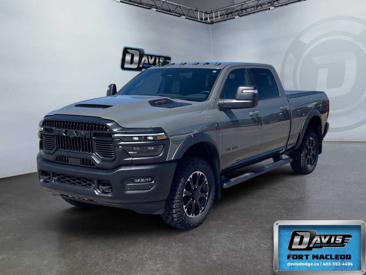 <p>Rev up your adventures with the <strong>2026 Ram 2500 Rebel</strong>, a powerhouse in a stunning gray with a robust 4x4 drivetrain. This truck delivers exceptional handling and performance, whether on the highway or tackling rugged trails.</p><p><strong>Interior Features:</strong></p><ul><li>Luxurious black leather-faced bucket seats that offer heated and ventilated options for ultimate comfort.</li><li>Convenient dual wireless charging pads to keep your devices powered up on the go.</li><li>Adaptive cruise control for stress-free long-distance drives.</li><li>A heated steering wheel ensuring comfort during those chilly Canadian winters.</li></ul><p><strong>Exterior Features:</strong></p><ul><li>A striking Sport Performance Hood and Diamond Black Crystal Pearl accents for a bold presence on the road.</li><li>MOPAR Rock Rails with Step Pad for added protection and convenience.</li><li>Convenient RAMBOX Cargo Management System featuring adjustable cargo tie-down hooks and LED bed lighting.</li><li>Deployable Bed Step and Tri-Fold Tonneau Cover enhancing utility and storage options.</li></ul><p><strong>Technology & Safety Features:</strong></p><ul><li>Advanced navigation system integrated with Bluetooth connection and smart device integration.</li><li>Comprehensive backup camera and parking sensors for effortless parking and reversing.</li><li>State-of-the-art lane assist and brake assist for enhanced safety.</li><li>Rain-Sensing Windshield Wipers and Automatic High-Beam Headlamp Control for optimal visibility in any weather.</li></ul><p>This exquisite Ram 2500 Rebel is built for those with a taste for adventure and the power to match. Come visit us at Davis Dodge Fort Macleod for a test drive and feel the raw power and luxury of this extraordinary truck. Don't miss out on owning a top-of-the-line performer that's ready for any challenge!</p>